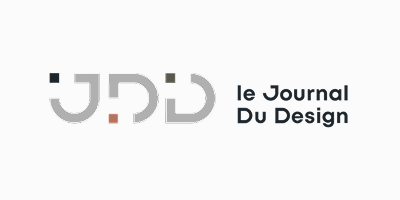 Logo of JDD, le Journal Du Design, with stylized letters and a dot above the 'J' in black and red, in a clean, modern font.
