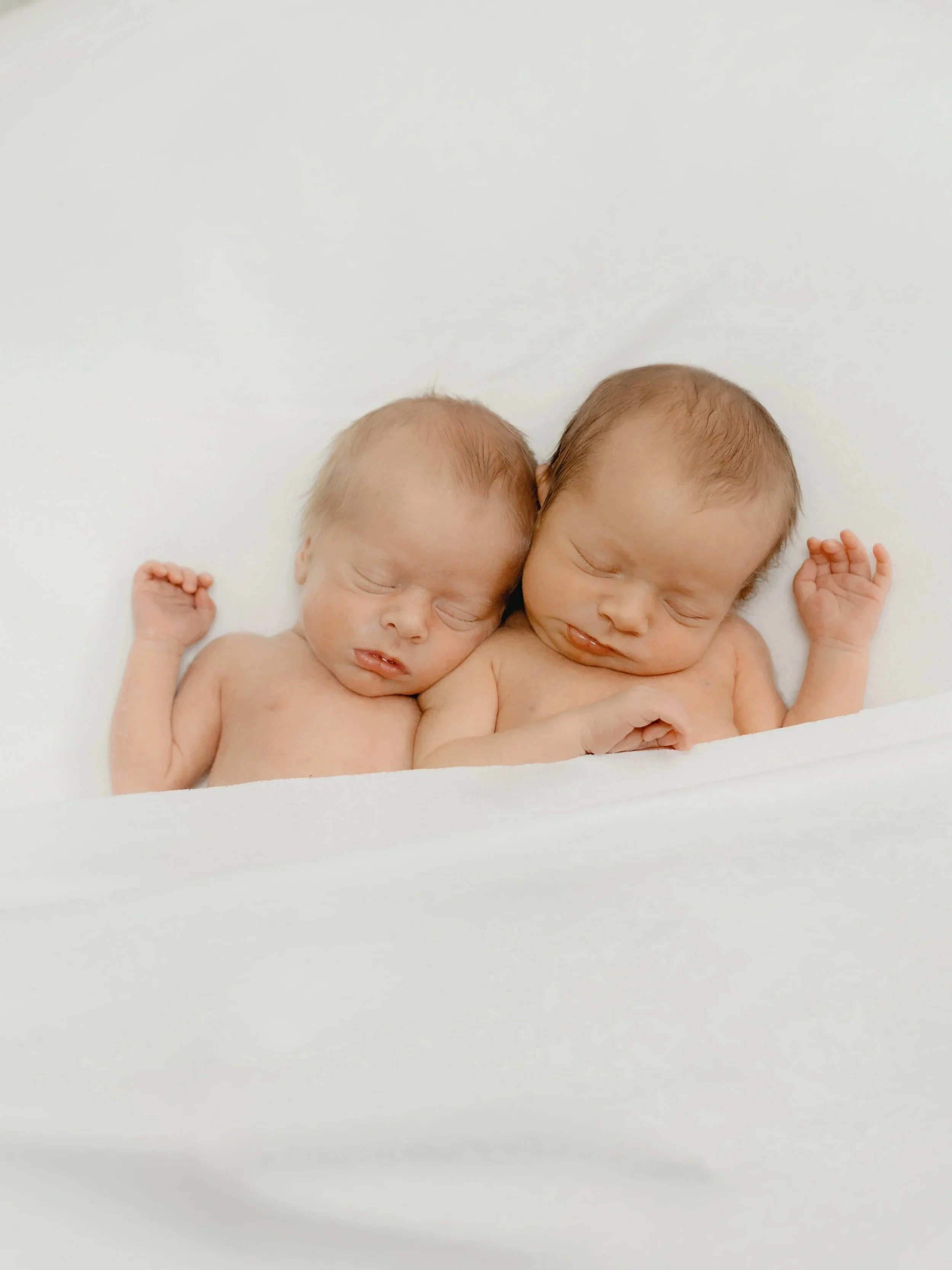 Newborn twins photographed together at Emma Rose Studio in Essex