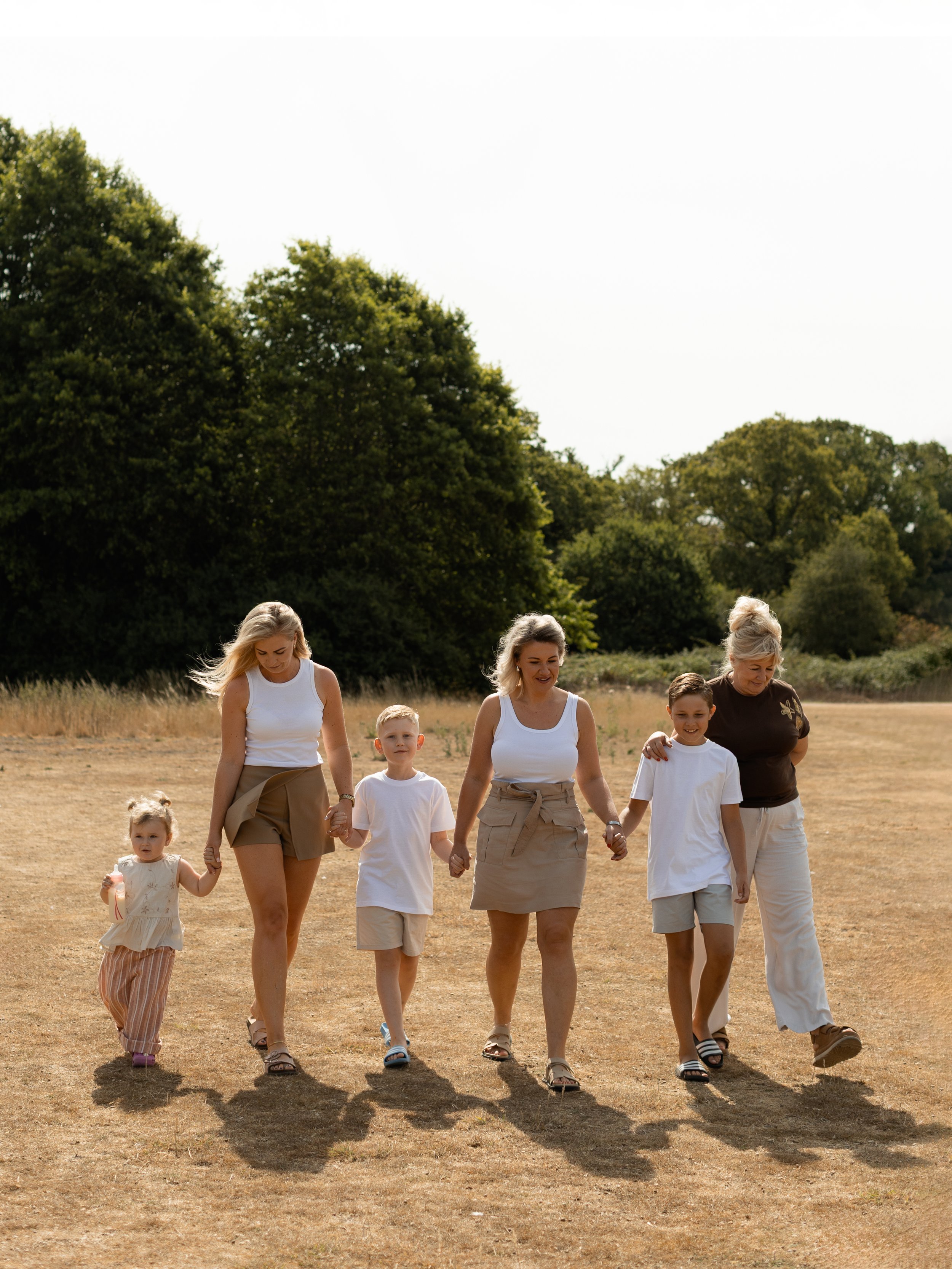 Multi-generational family walking together during a relaxed outdoor family photography session in Essex.