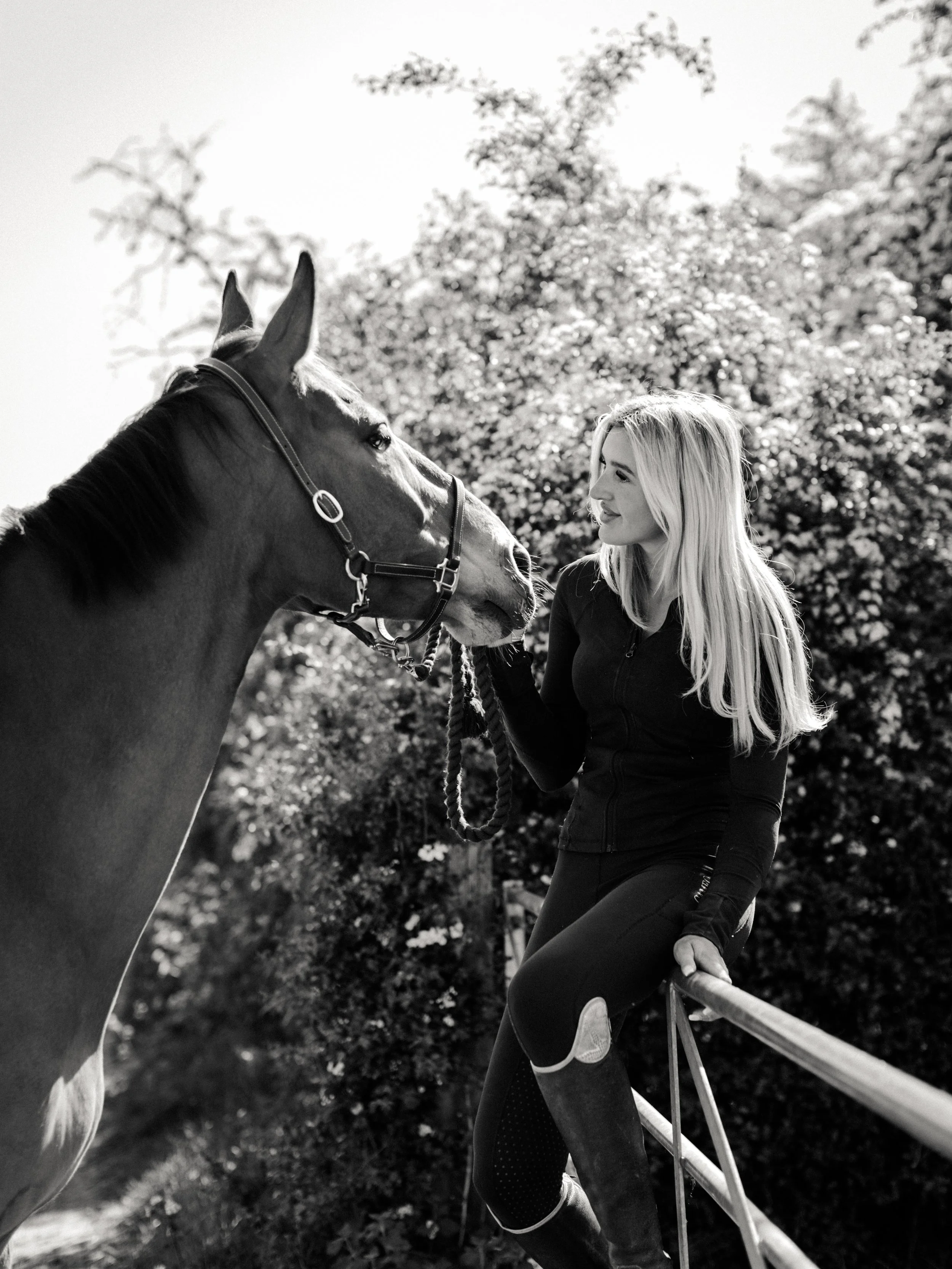 Black and white portrait of a woman with her horse during an outdoor equine photography session.