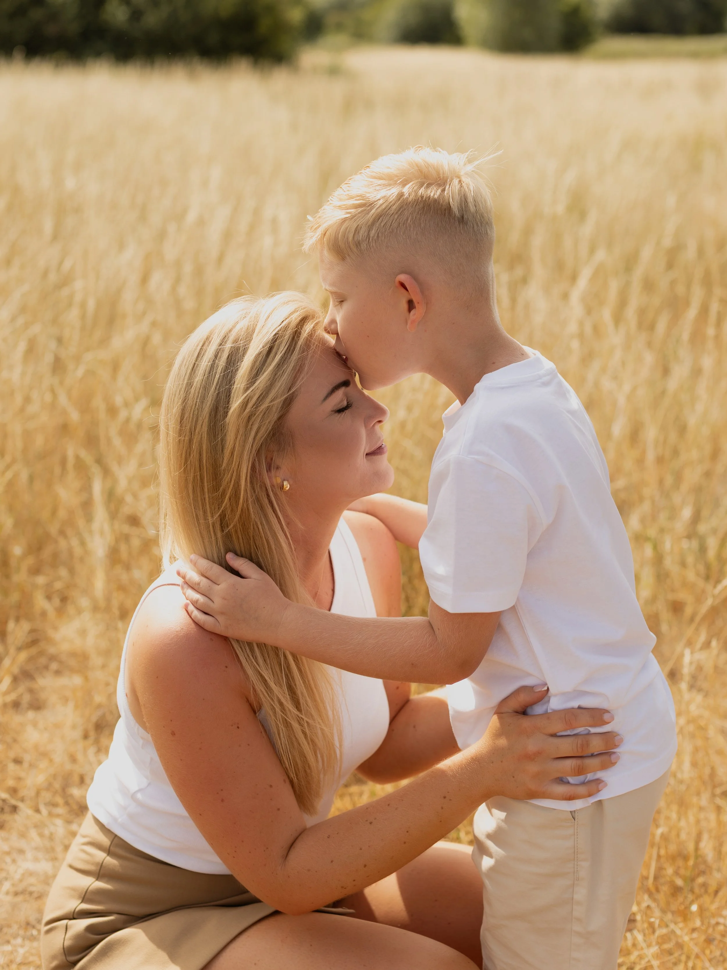 Mum sharing a close moment with her son during an outdoor family photography session.