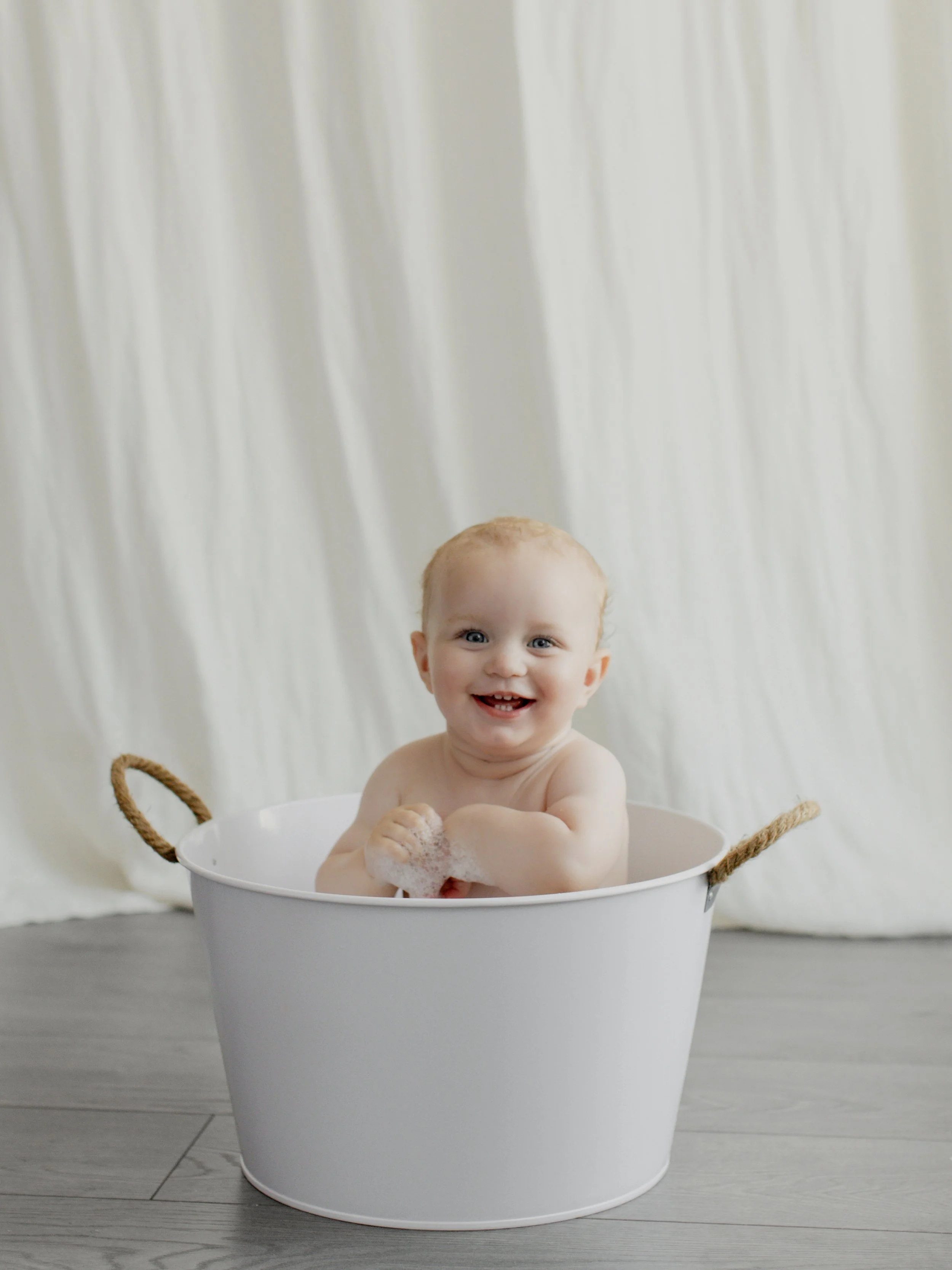 photography-essex.jpg Smiling baby having a bubble bath after a first birthday cake smash photography session
