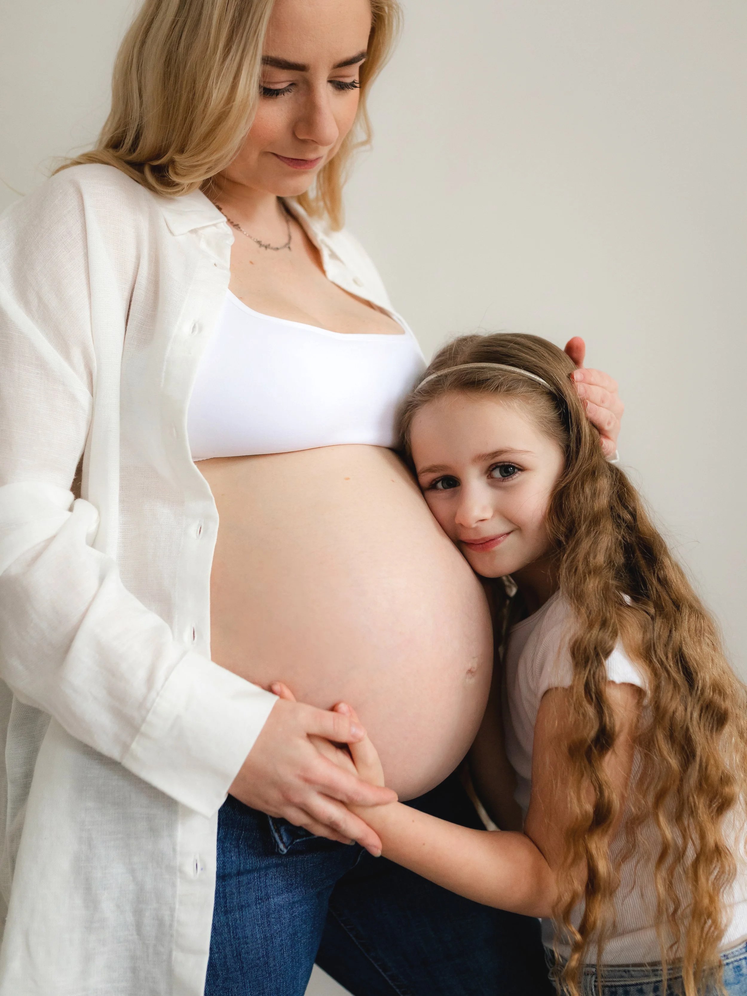 Expectant mother and daughter together during a maternity photography session in South Ockendon, Essex