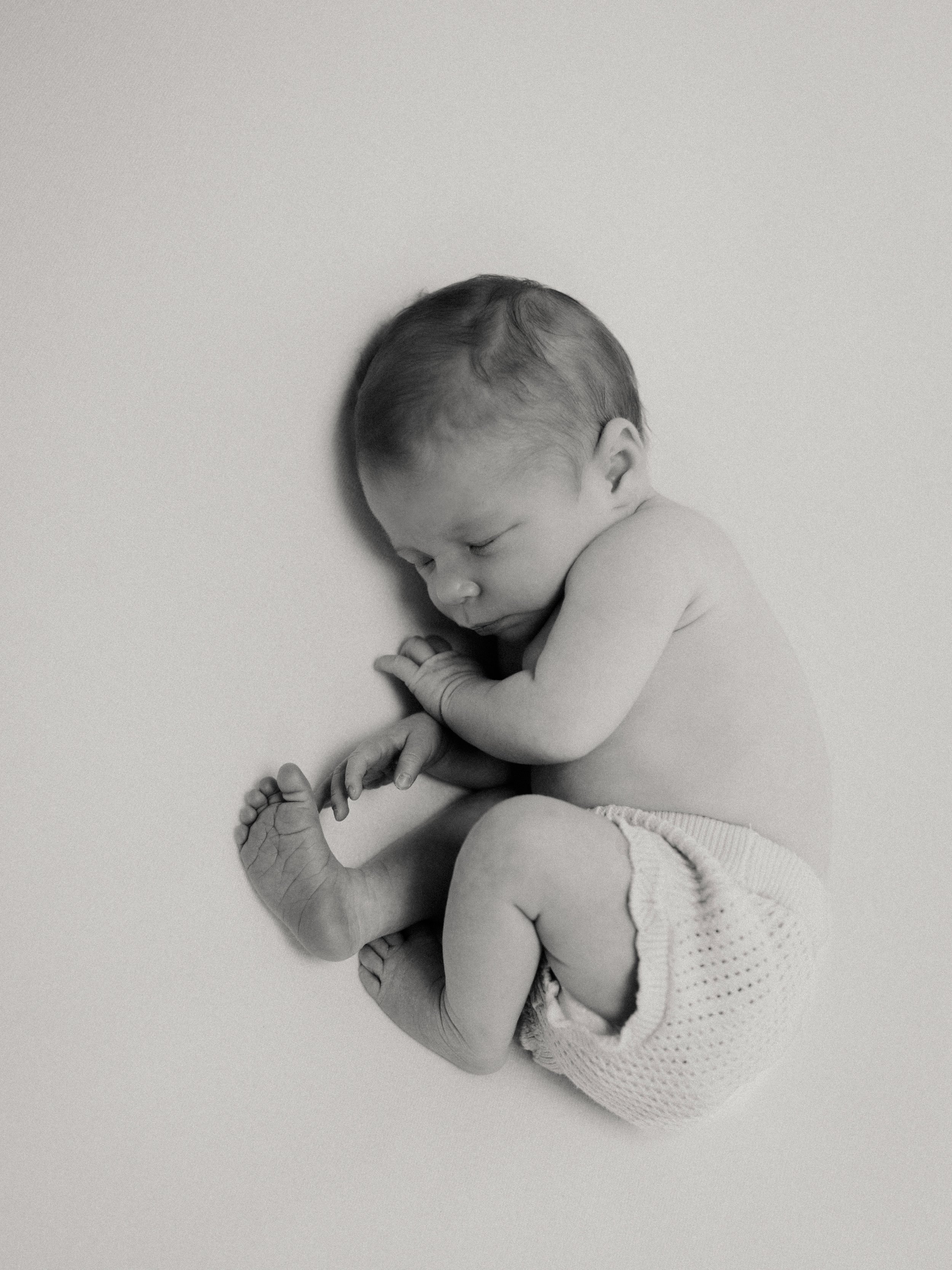 Black and white portrait of a sleeping newborn baby