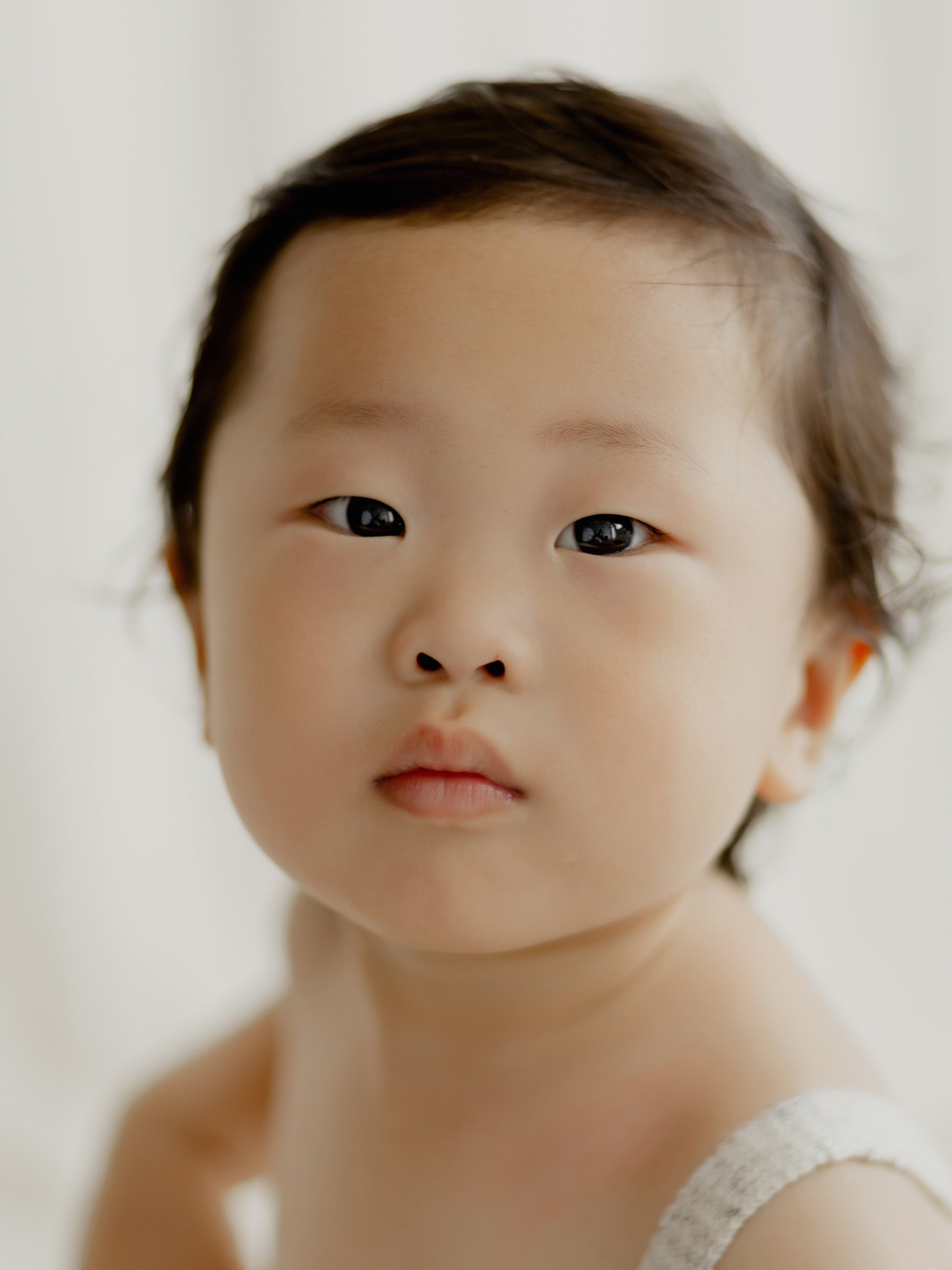 Close-up portrait of a young child during a natural milestone photography session in Essex.