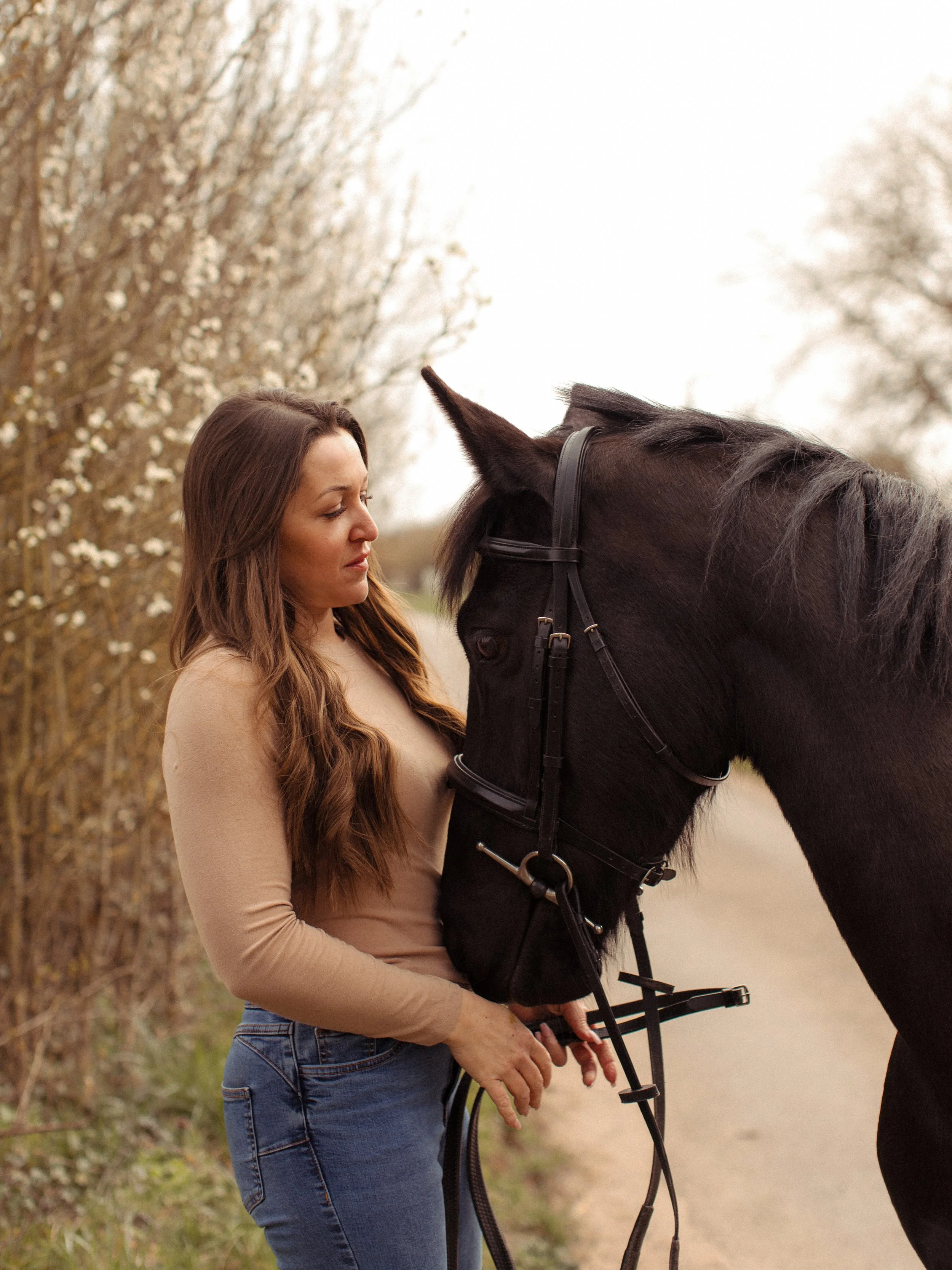 Woman sharing a relaxed moment with her horse during an outdoor equine photography session in Essex.