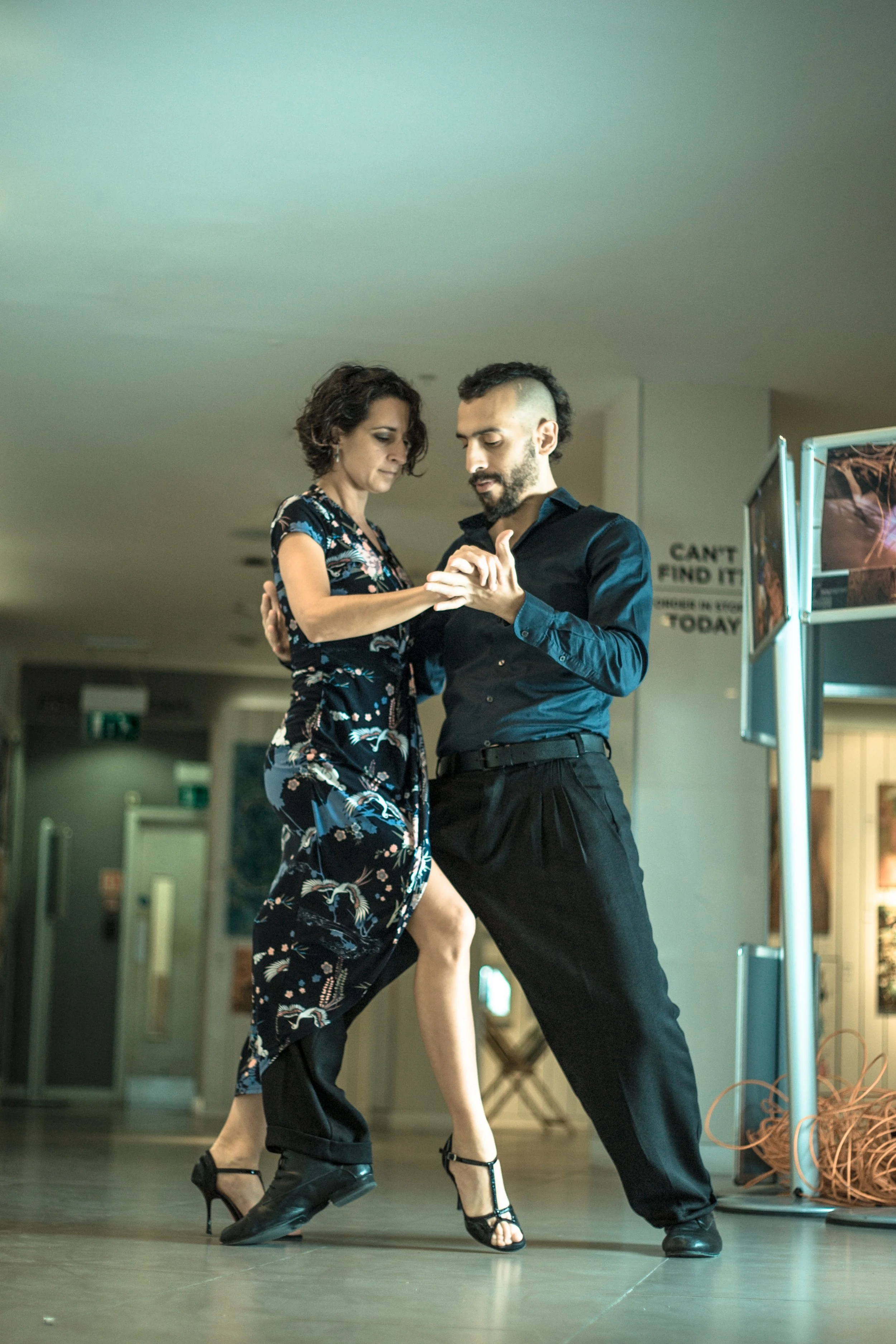 Two dancers facing towards each other