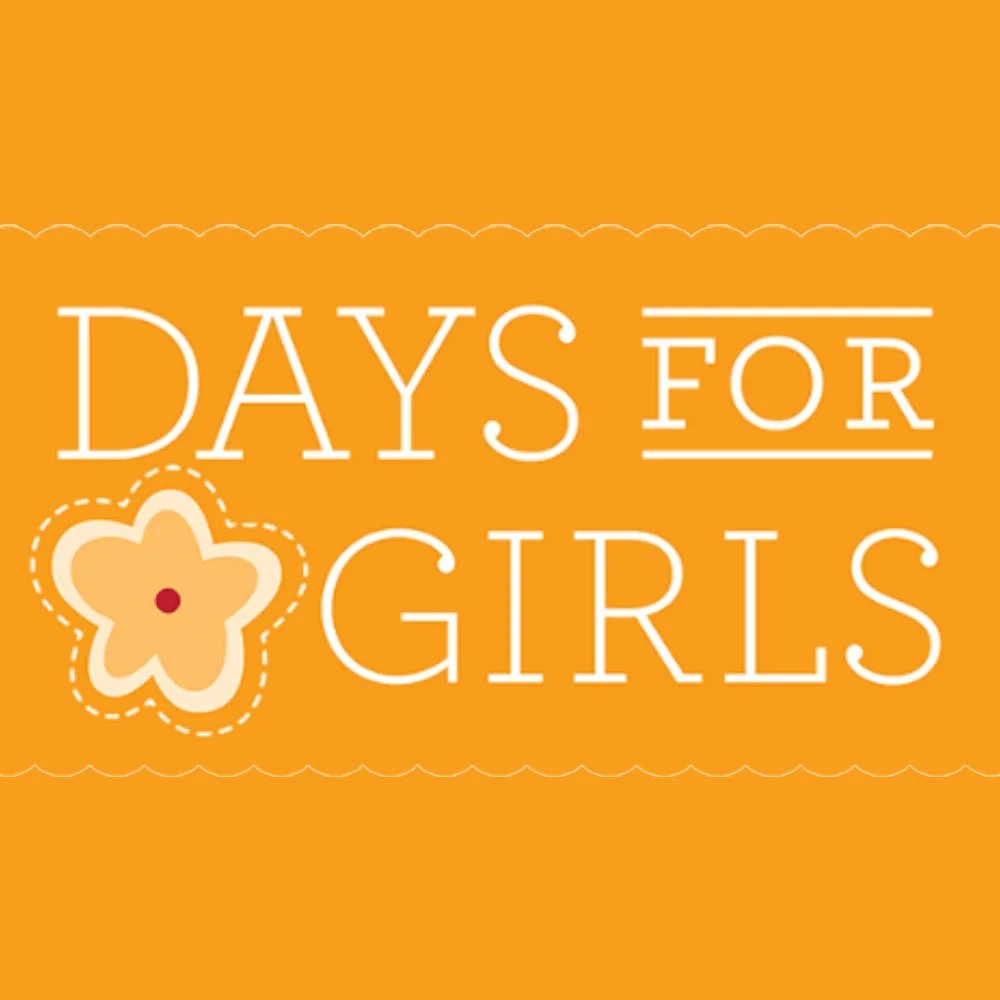 Orange background with white text that reads "DAYS FOR GIRLS" and a stylized flower graphic with a red center.