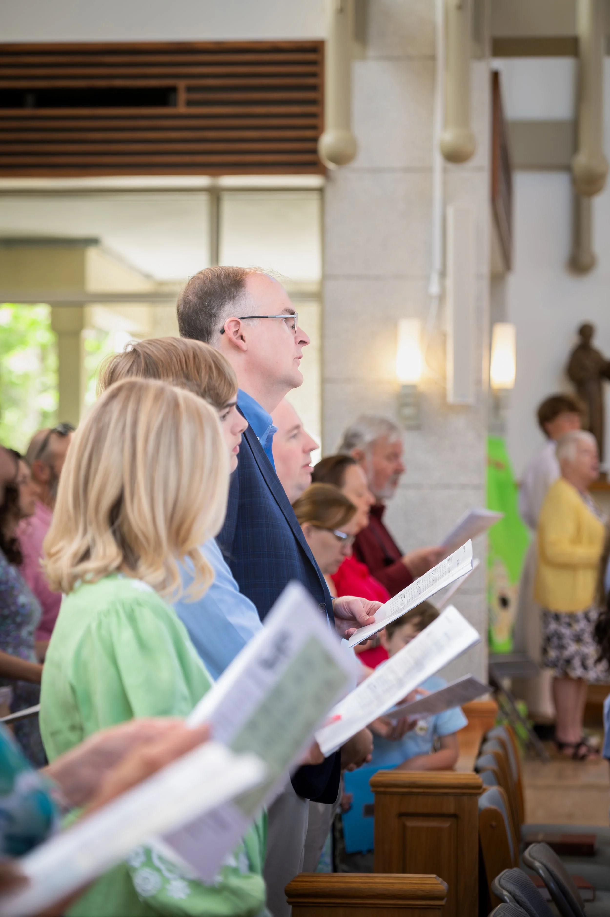 Church members standing in pew during service.jpg