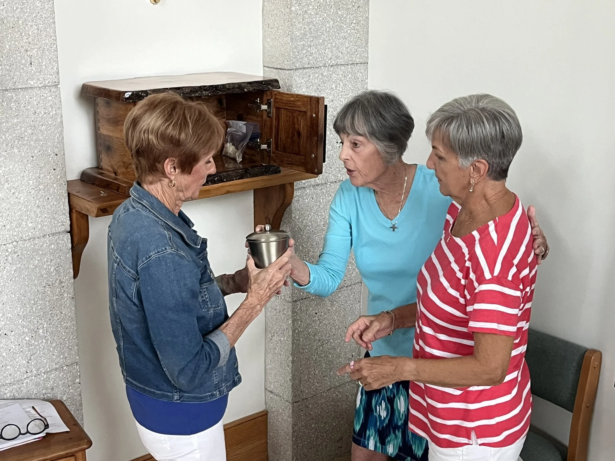 Altar Guild members with communion elements at the tabernacle