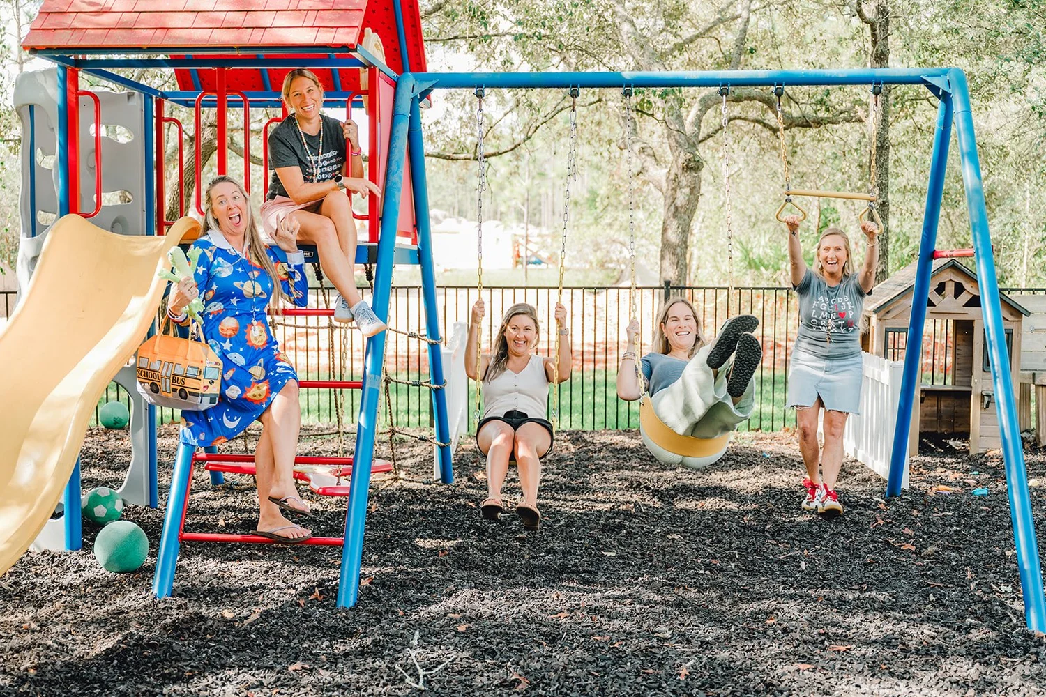 The Little Flowers teachers together on the playground