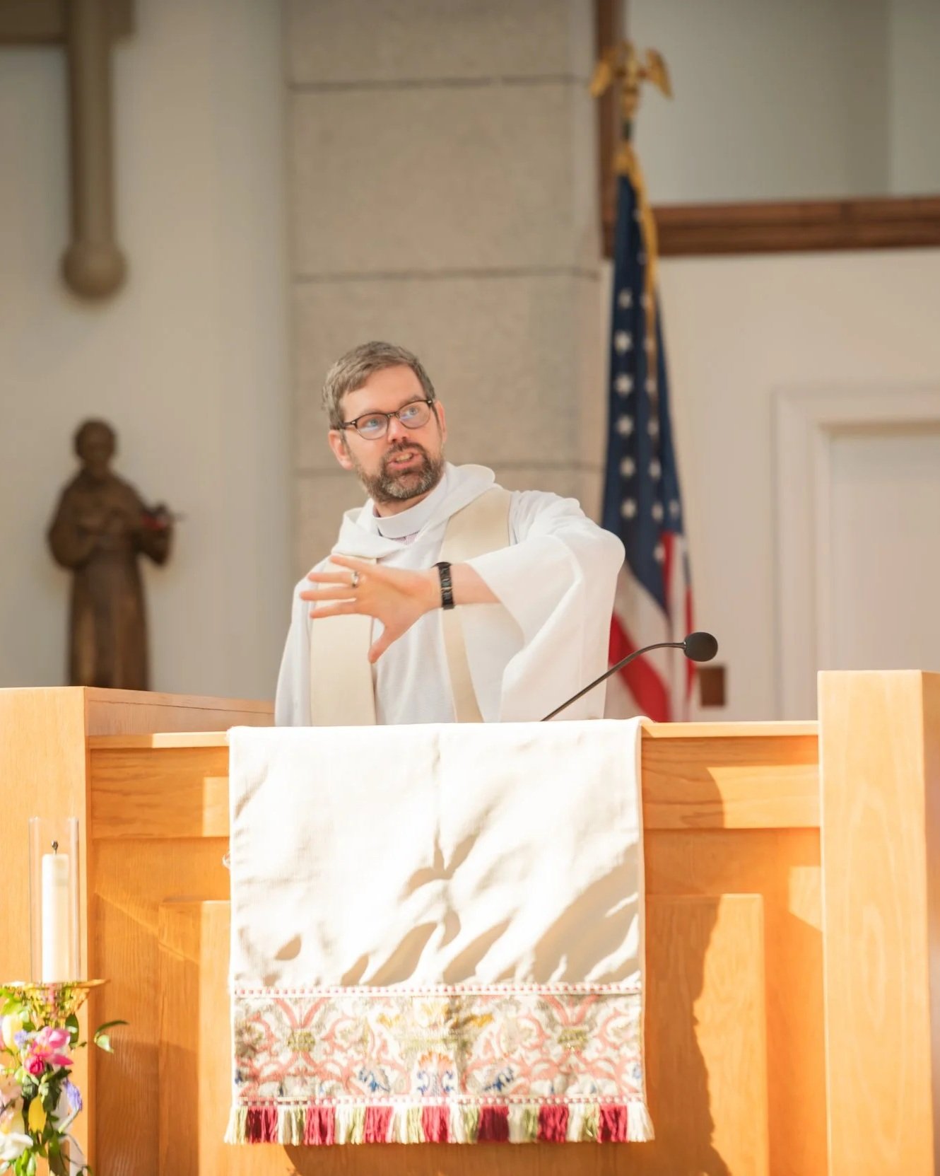 Deacon Markand a young family at Baptism service