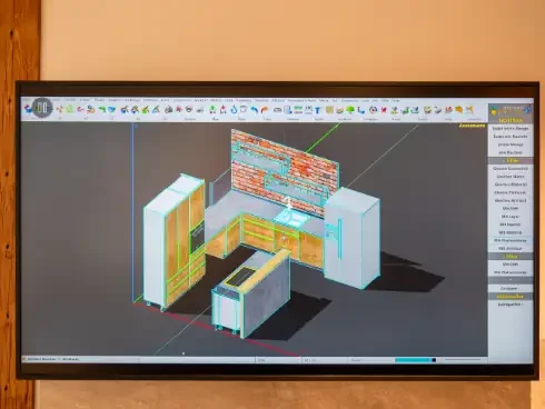 Bild eines Computerbildschirms mit einer 3D-Küchendesign-Software, die eine Küche in Planung zeigt.