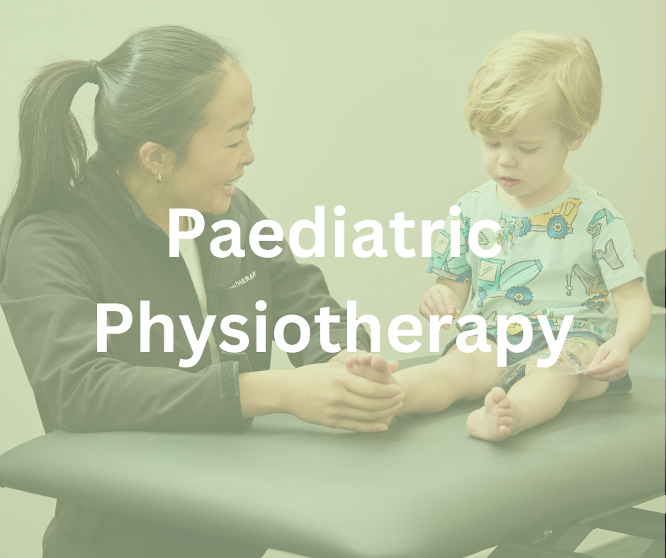 A pediatric physiotherapist examining a young boy's leg in a clinical setting, with both smiling.