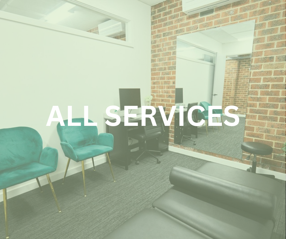 An office waiting area with green chairs, black desks, and a large mirror on a brick wall, with the text 'ALL SERVICES' overlayed.