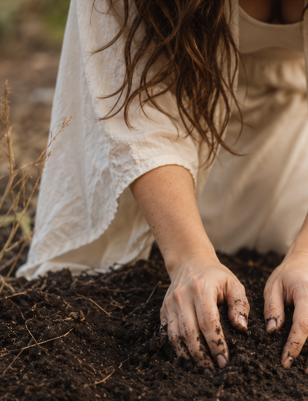 woman's hands in soil