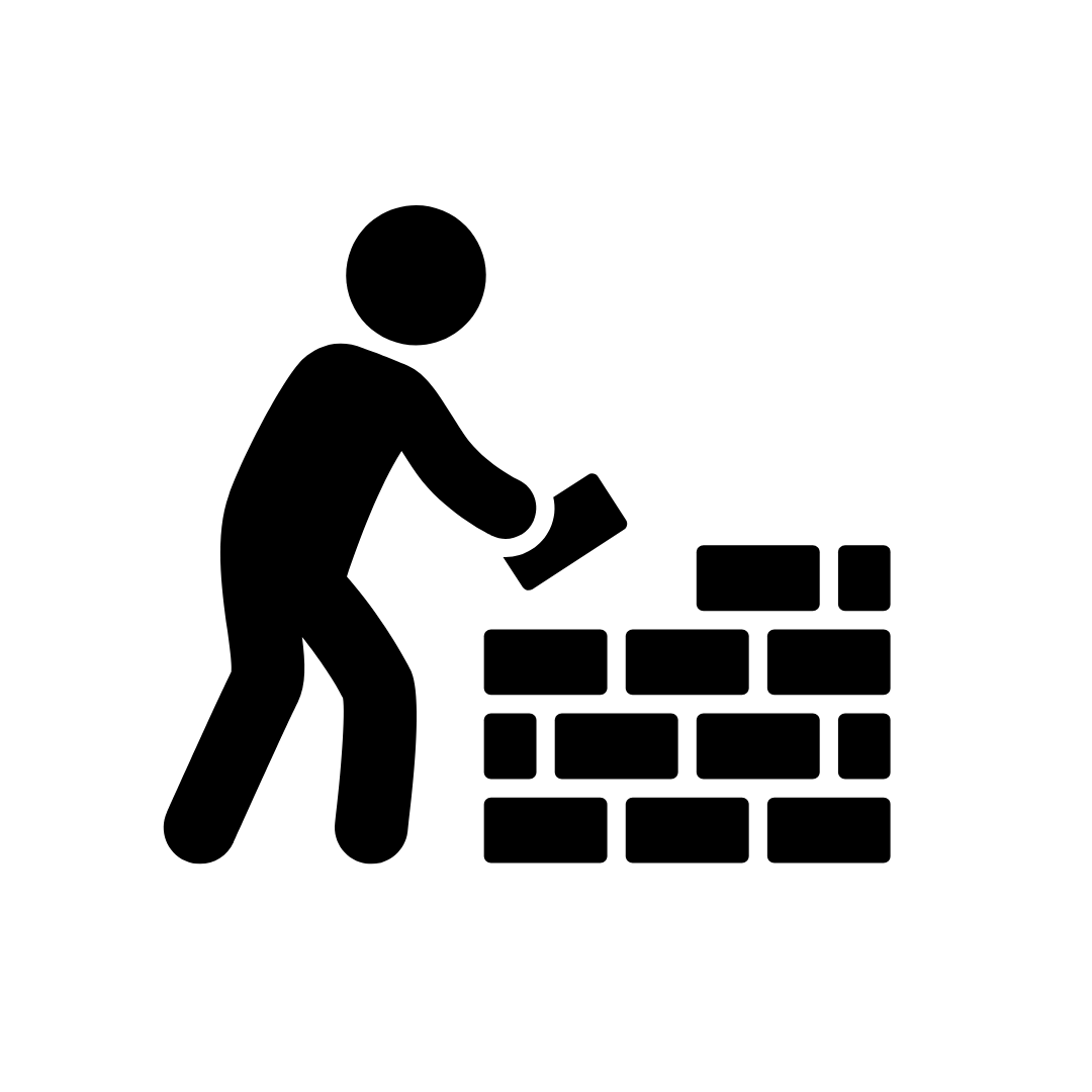 Silhouette of a person building a brick wall.