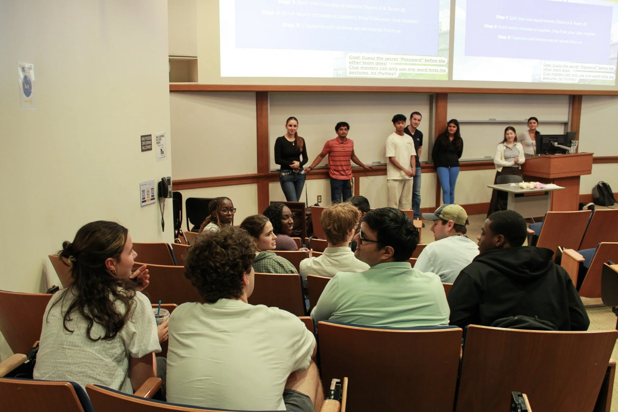 Portrait of an older man with gray hair and beard, wearing a beige blazer over a white shirt, smiling against a plain light background.