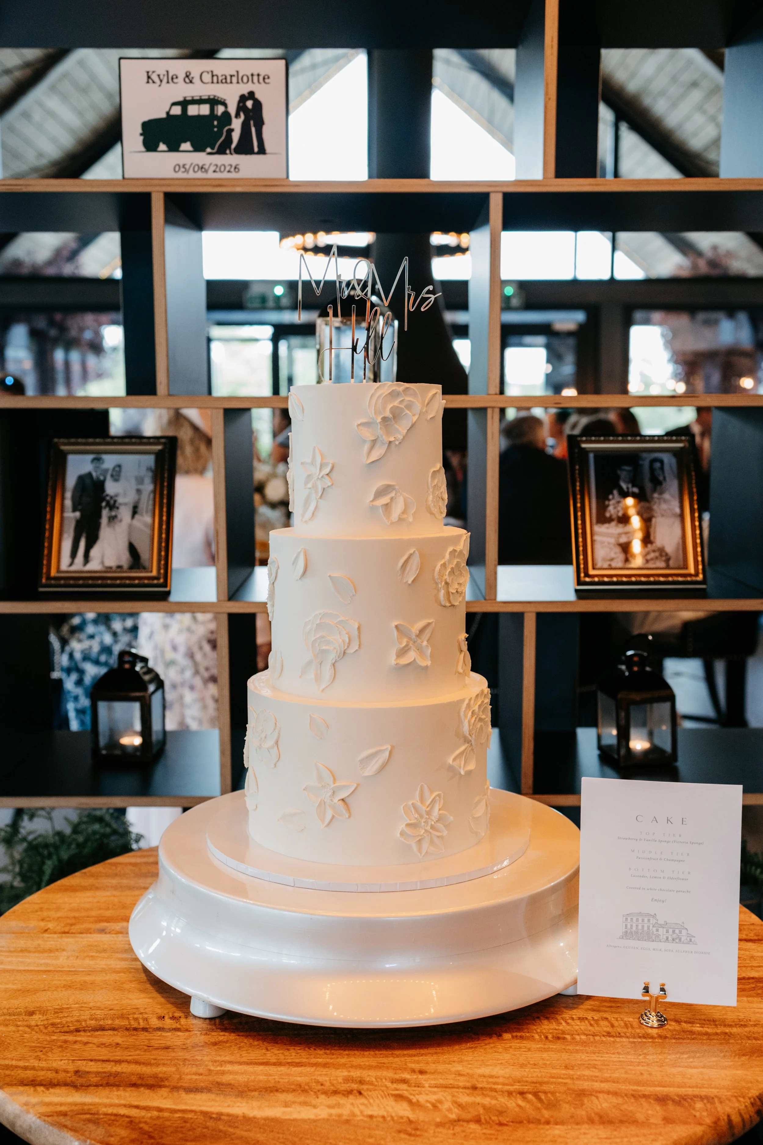 Luxury three-tier white chocolate ganache wedding cake with handcrafted floral detailing by CK Bakes.