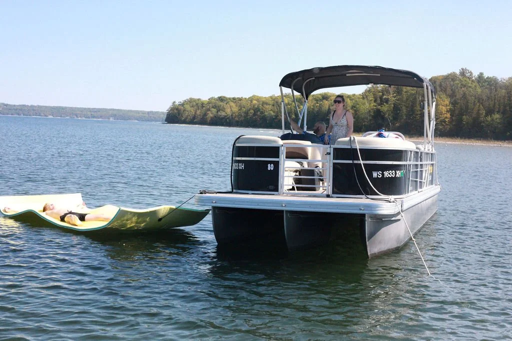 Person laying on a lily pad while on a boat at Peninsula State Park