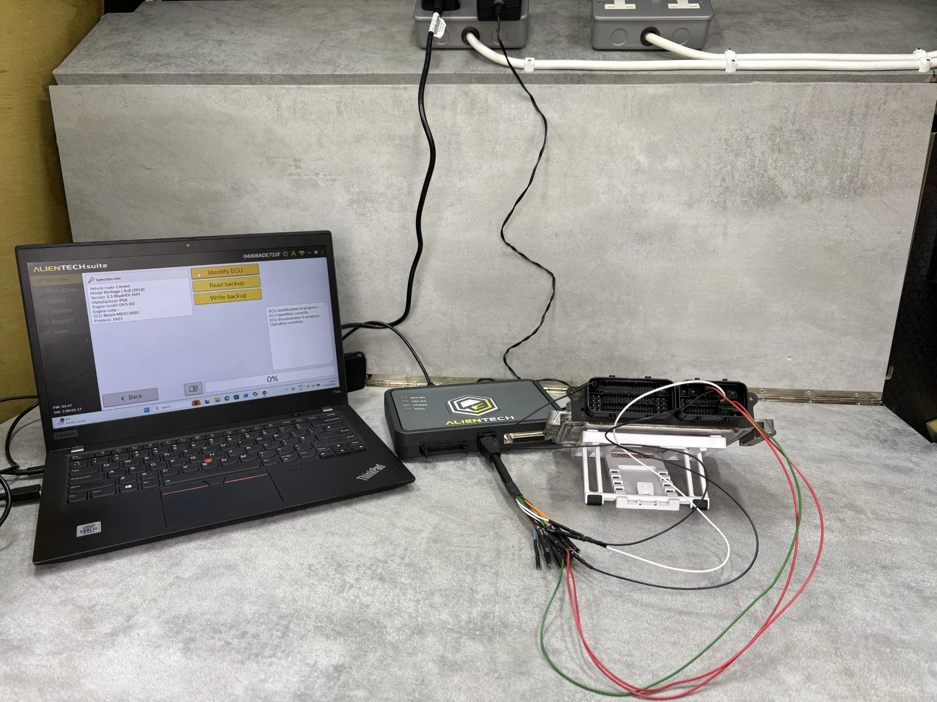 Specialist bench remapping and ECU software solutions in Kent: Kent Eco Tuning expert tuning a car engine control unit.