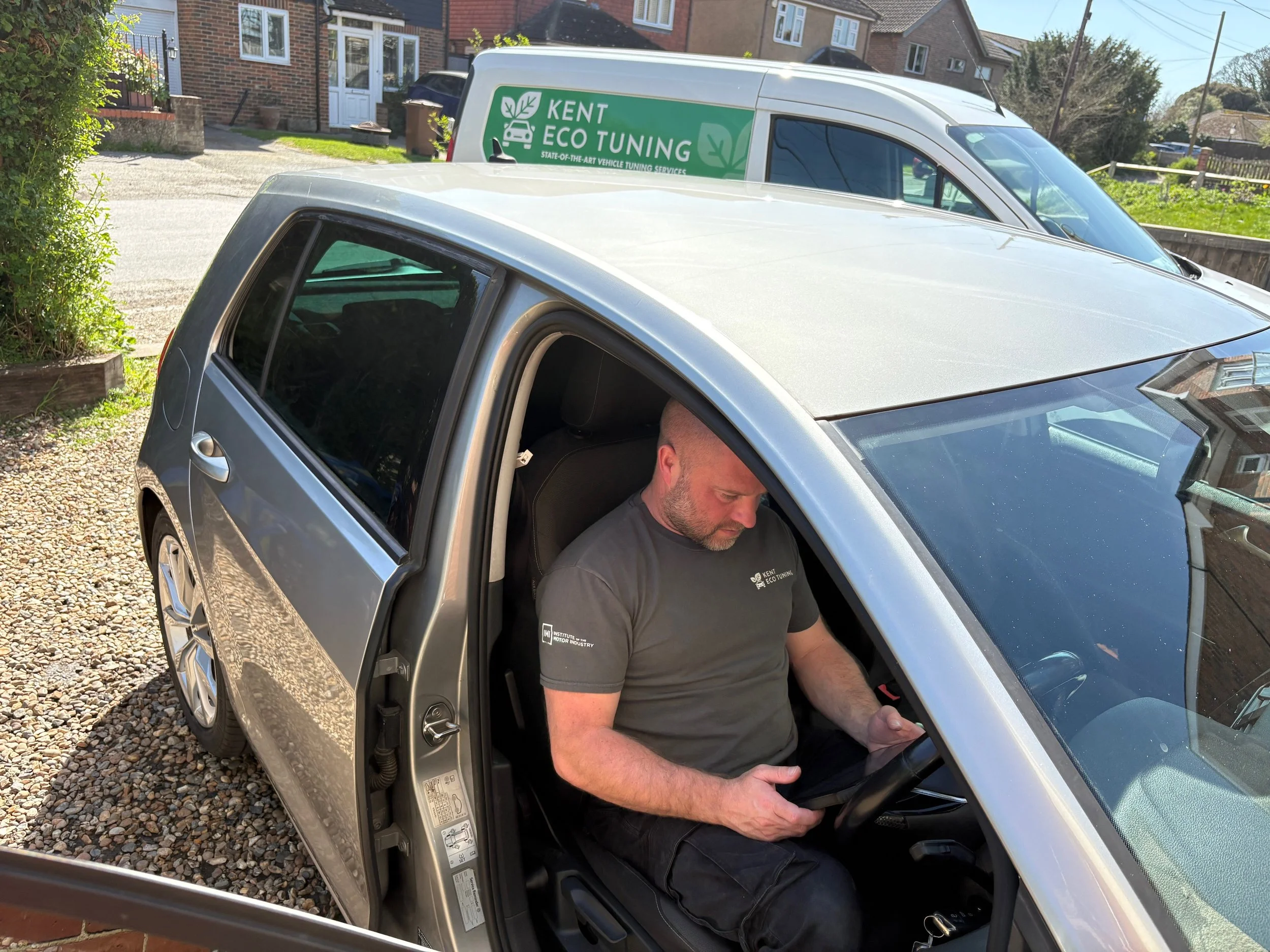 Car tuning diagnostics Rochester - Technician using tablet in silver car