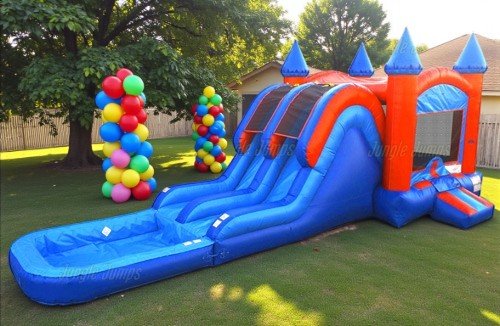 Colorful inflatable bounce house with a slide in a backyard with trees and balloons
