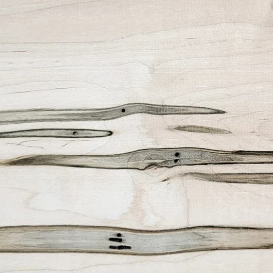 Close-up of light-colored wooden planks with dark knots and grain patterns.