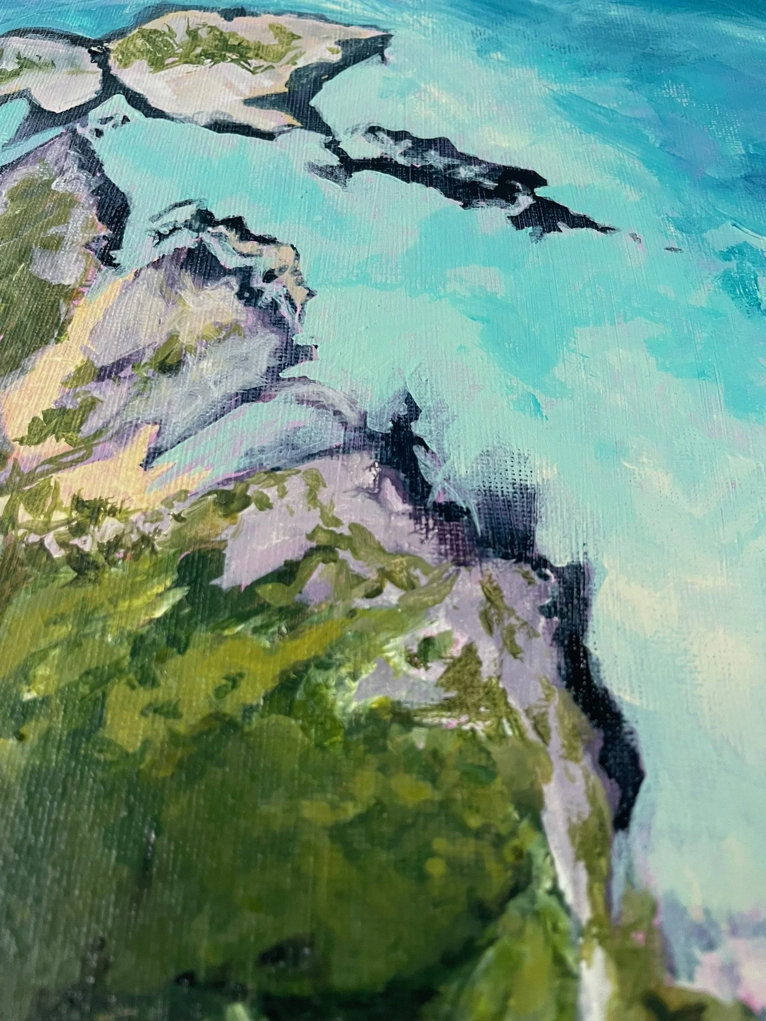 Close-up of a landscape painting depicting a rocky cliff with green vegetation, under a blue sky with clouds.