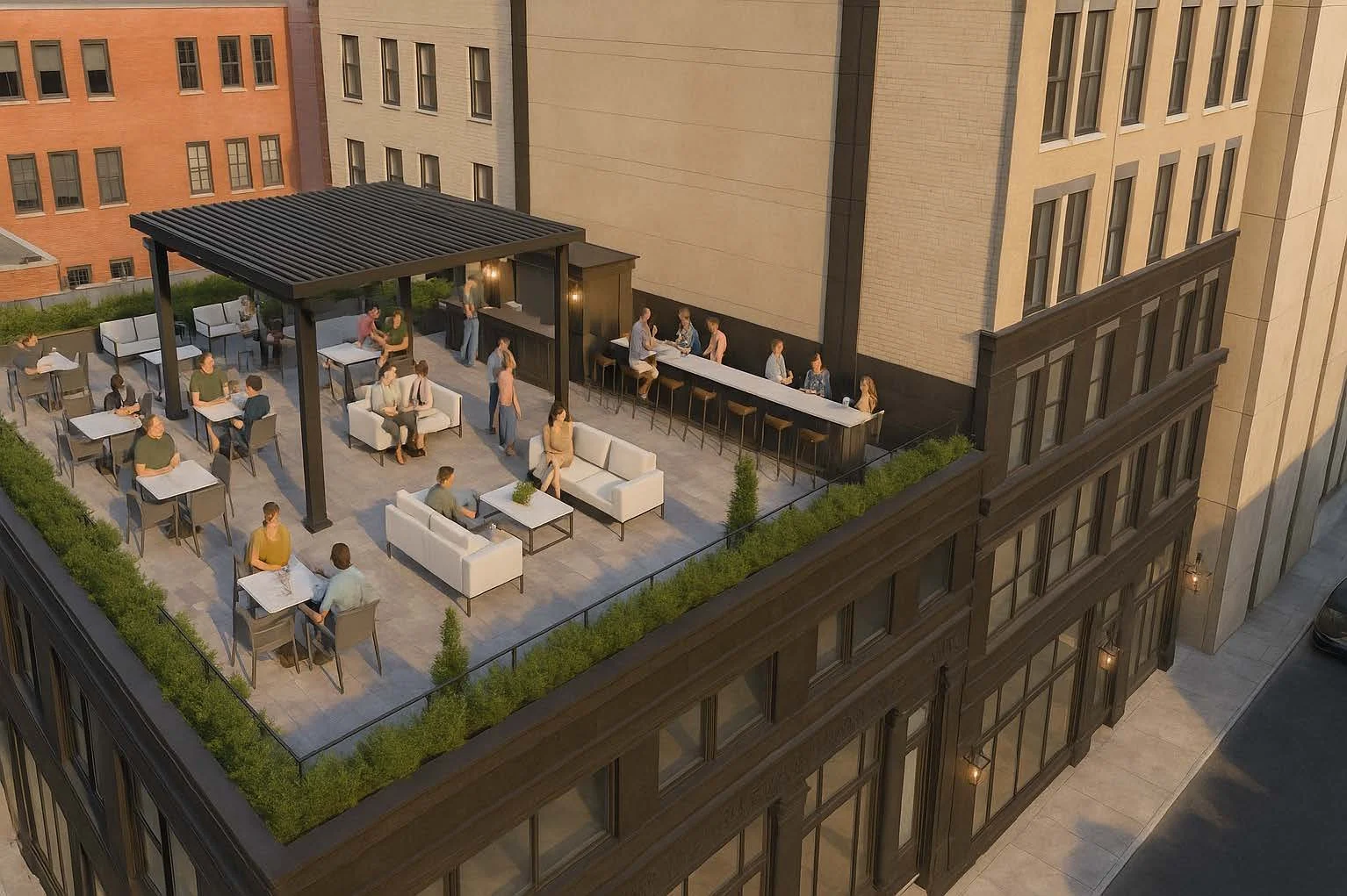 Roof top outdoor seating area with tables, chairs, and sofas for people socializing, set against tall building walls.