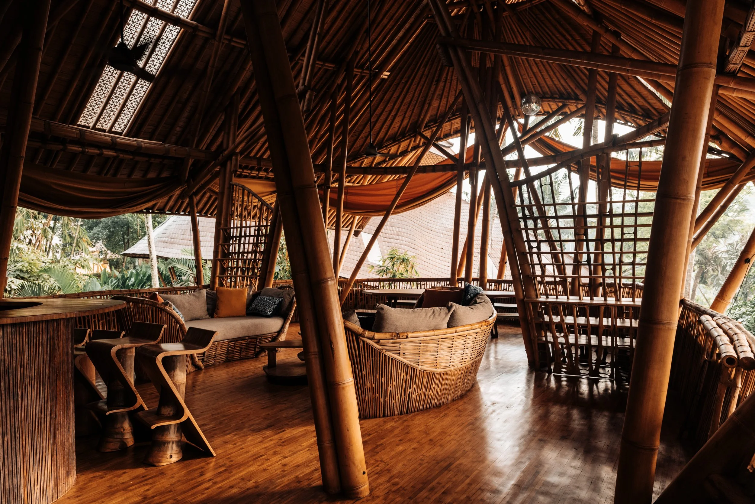 Detail of hand-carved bamboo furniture, Villa Kelapa, Bali. Local craftsmanship and organic design captured in natural light. Architectural interior photography.