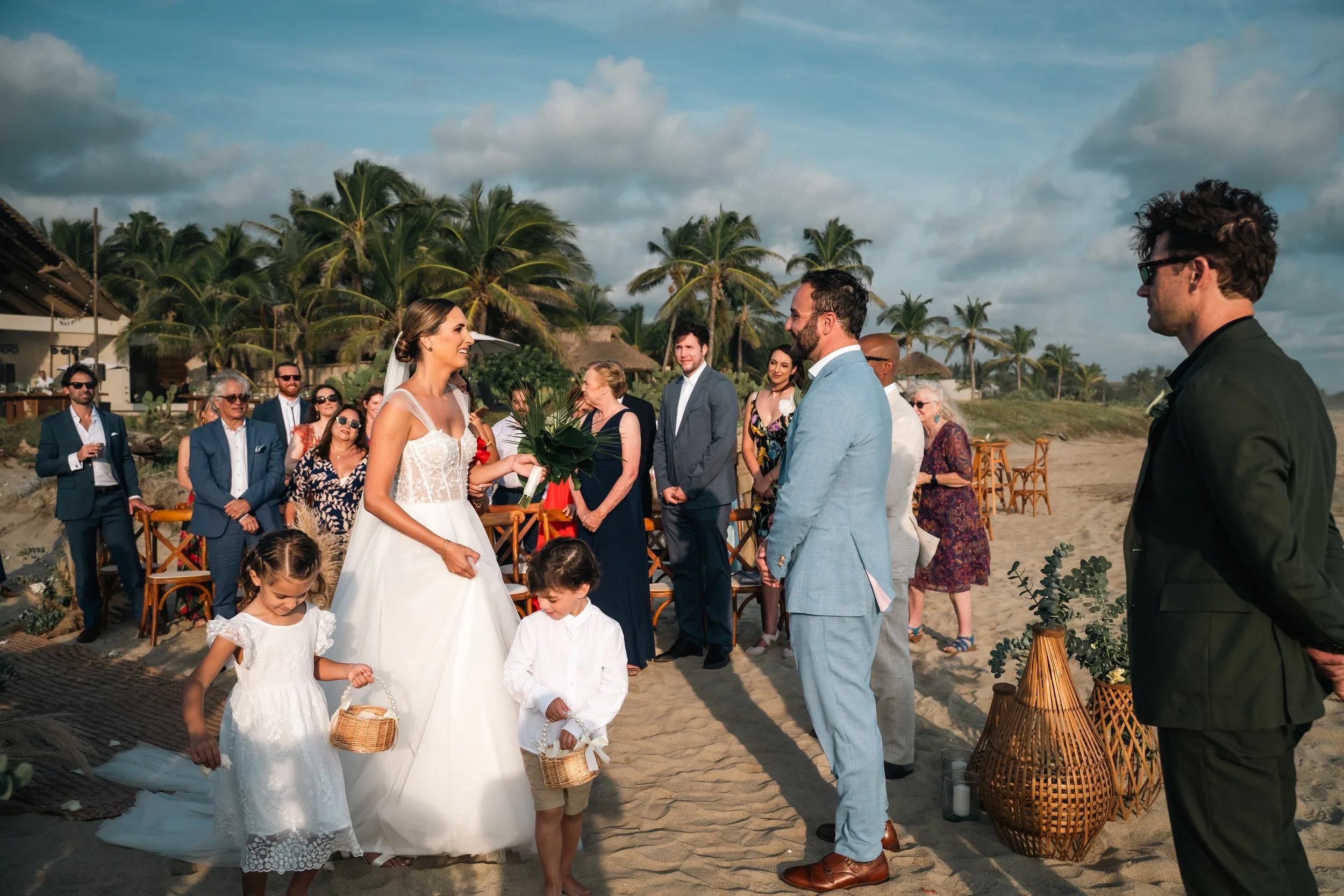 Sunset moments during a destination wedding in Puerto Escondido, captured at a private luxury villa for an American couple. Walking the Alley very happy maried couple.