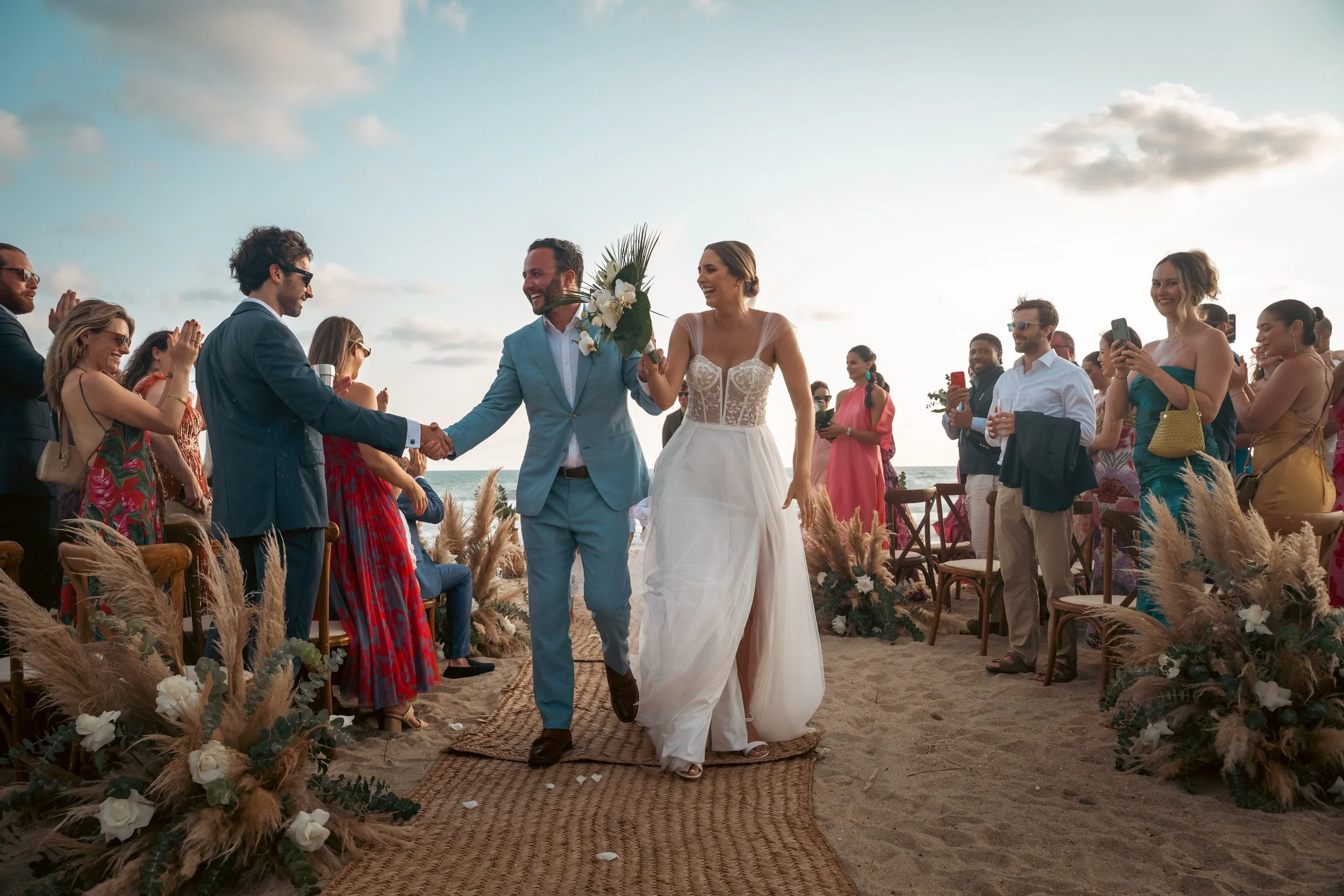 Sunset moments during a destination wedding in Puerto Escondido, captured at a private luxury villa for an American couple. Walking the Alley very happy maried couple.