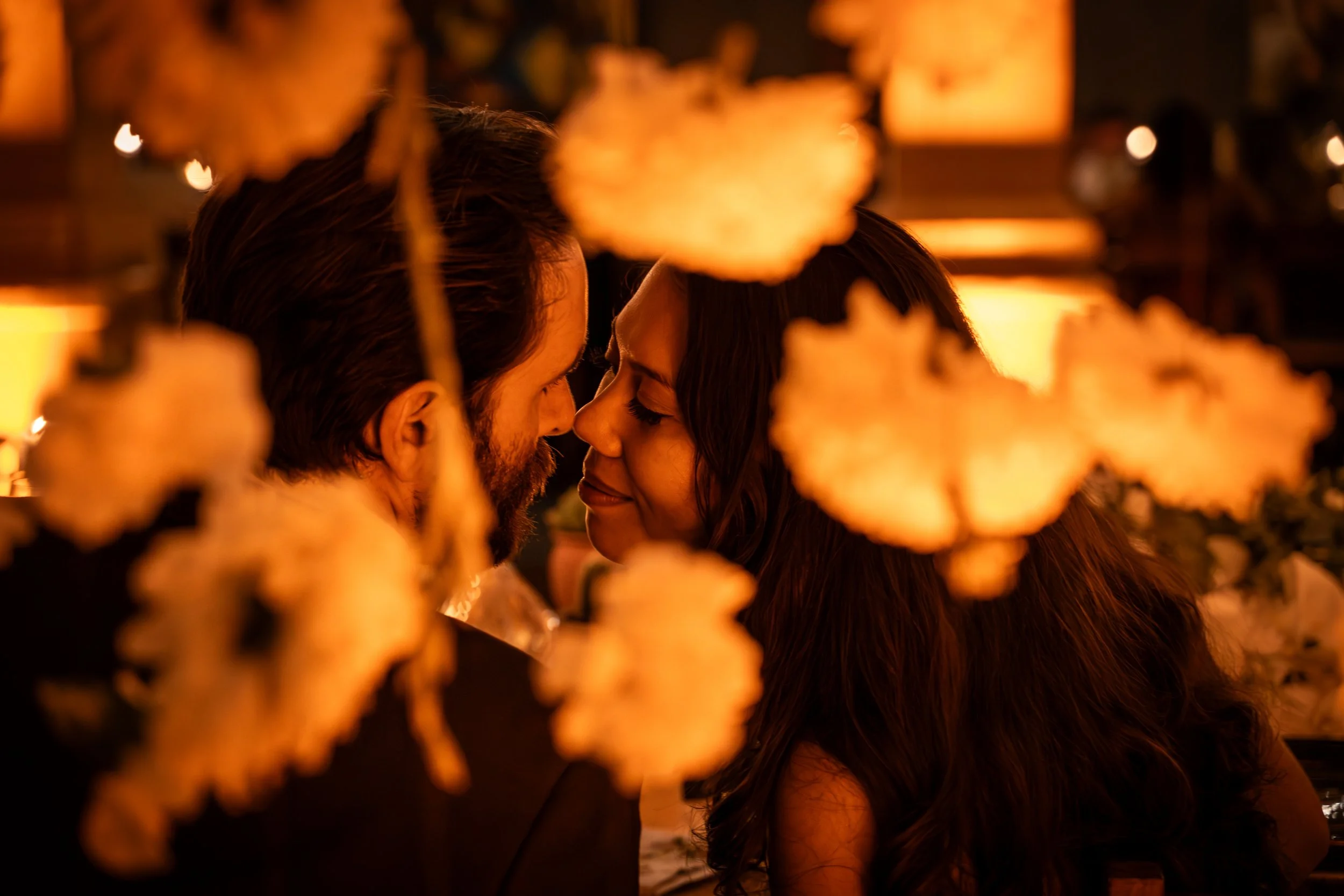Maried Couple looking at each other during gthe diner of their destination Wedding in Oaxaca city. wedding photographer Julien Andre Megoz