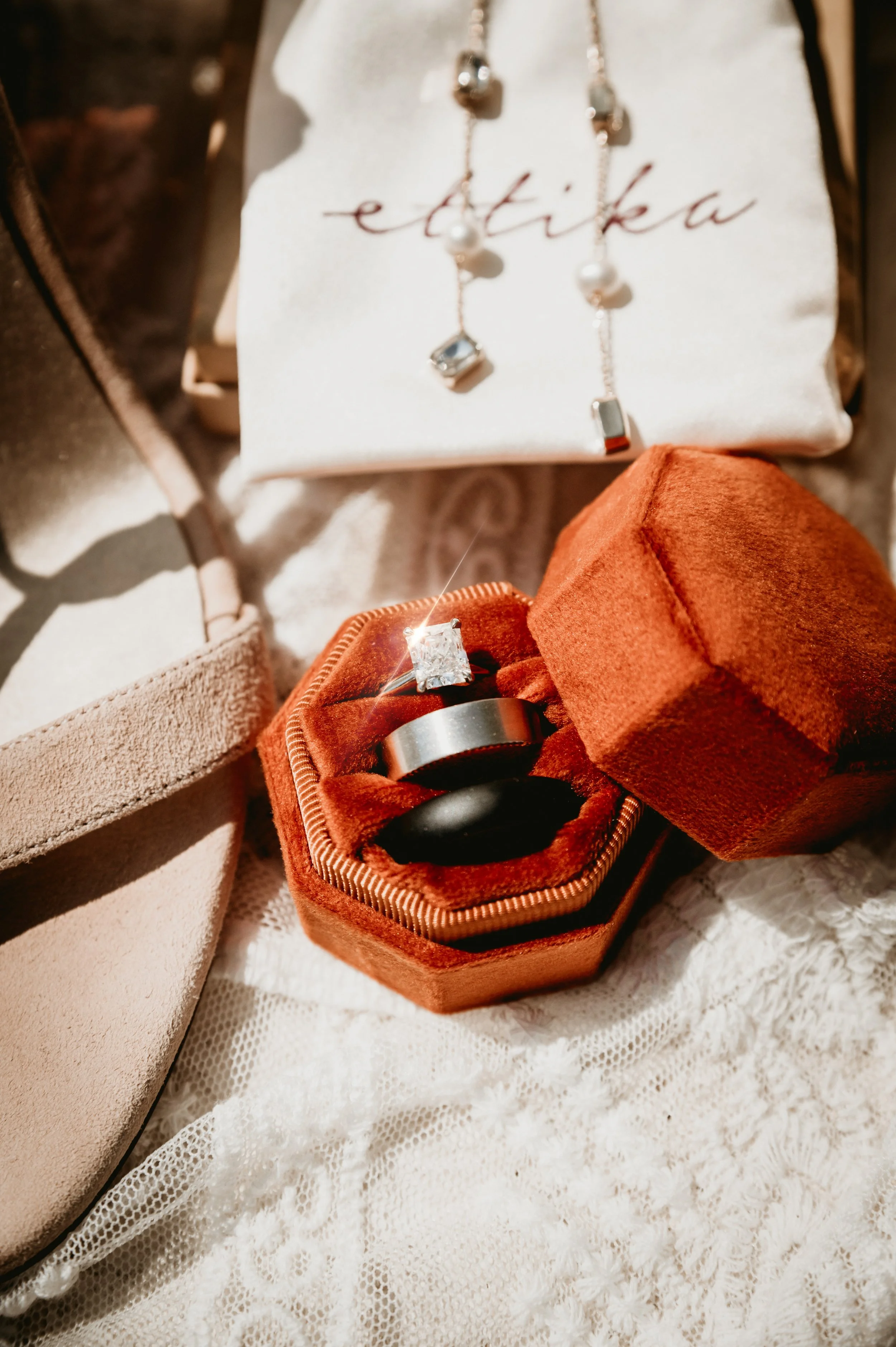 Close up of a set of luxurious wedding rings, editorial image with a beautiful diamond, women shoe and jewelry.