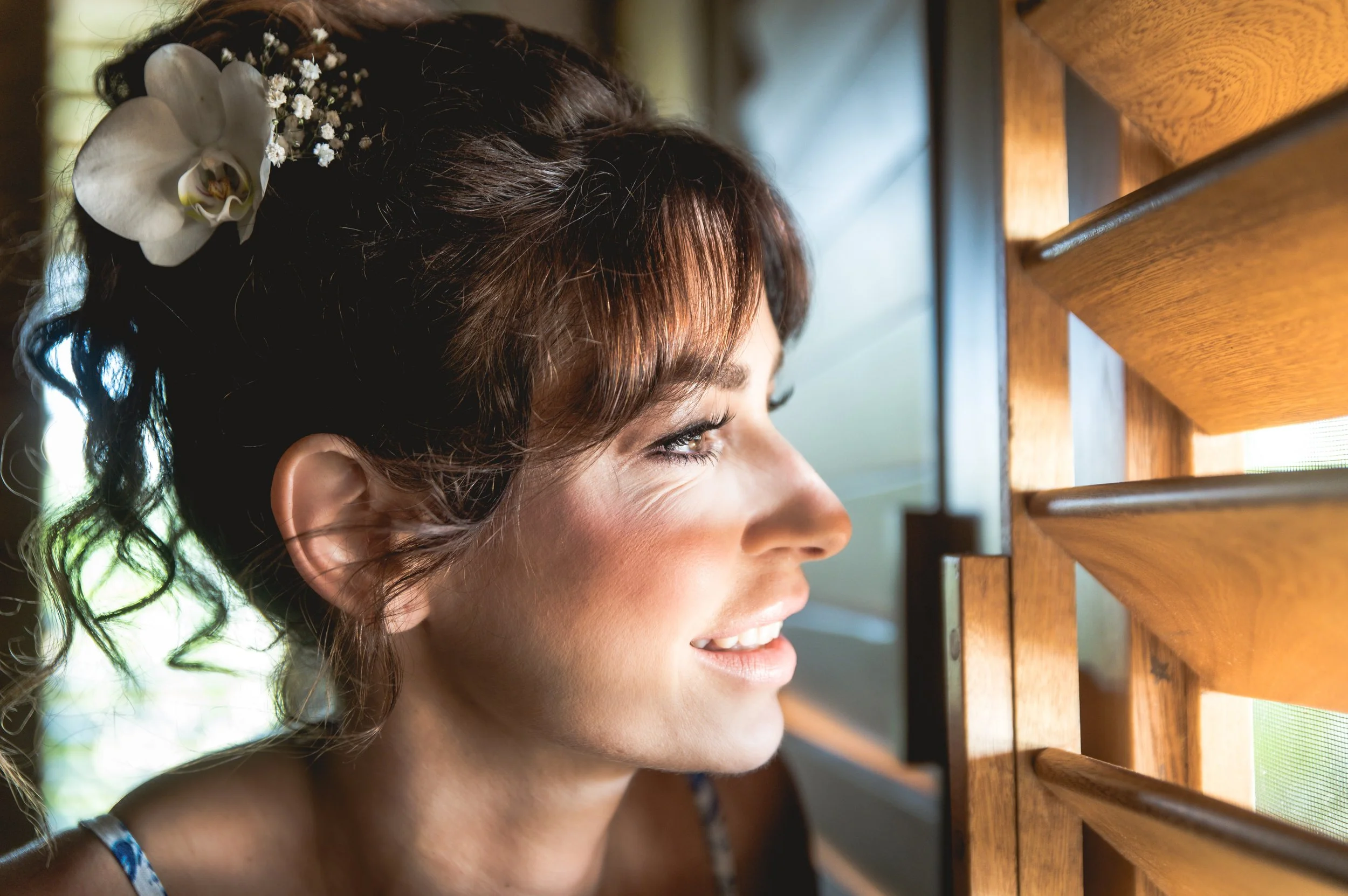 Beautiful profesional wedding photography of a bride looking through a window for her husband in a luxury villa in Puerto Escondido.