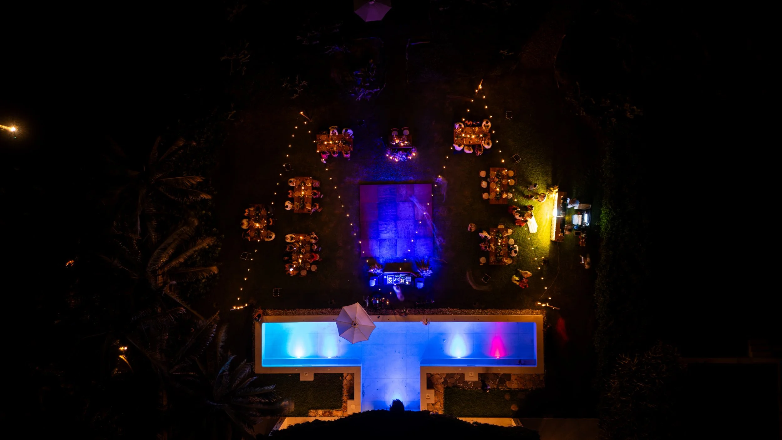 Drone shot of dancing floor in wedding party. Very happy vibes and colorfull. nice light beam in luxurious Villa in Puerto Escondido