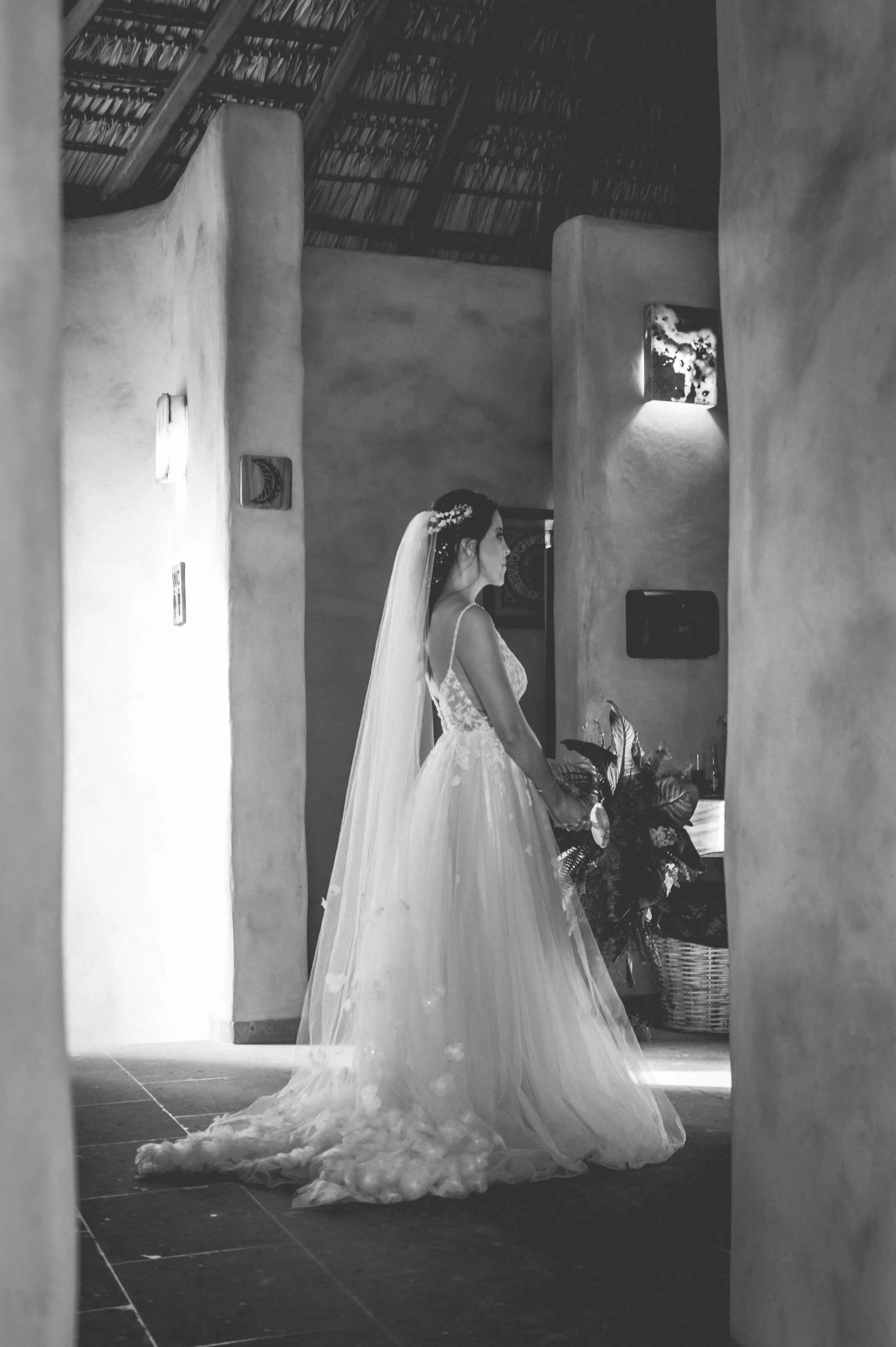 Beautiful profesional wedding photography of a bride looking  a windherself in the mirror before walking the alley to meet her husband in a luxury villa in Puerto Escondido.