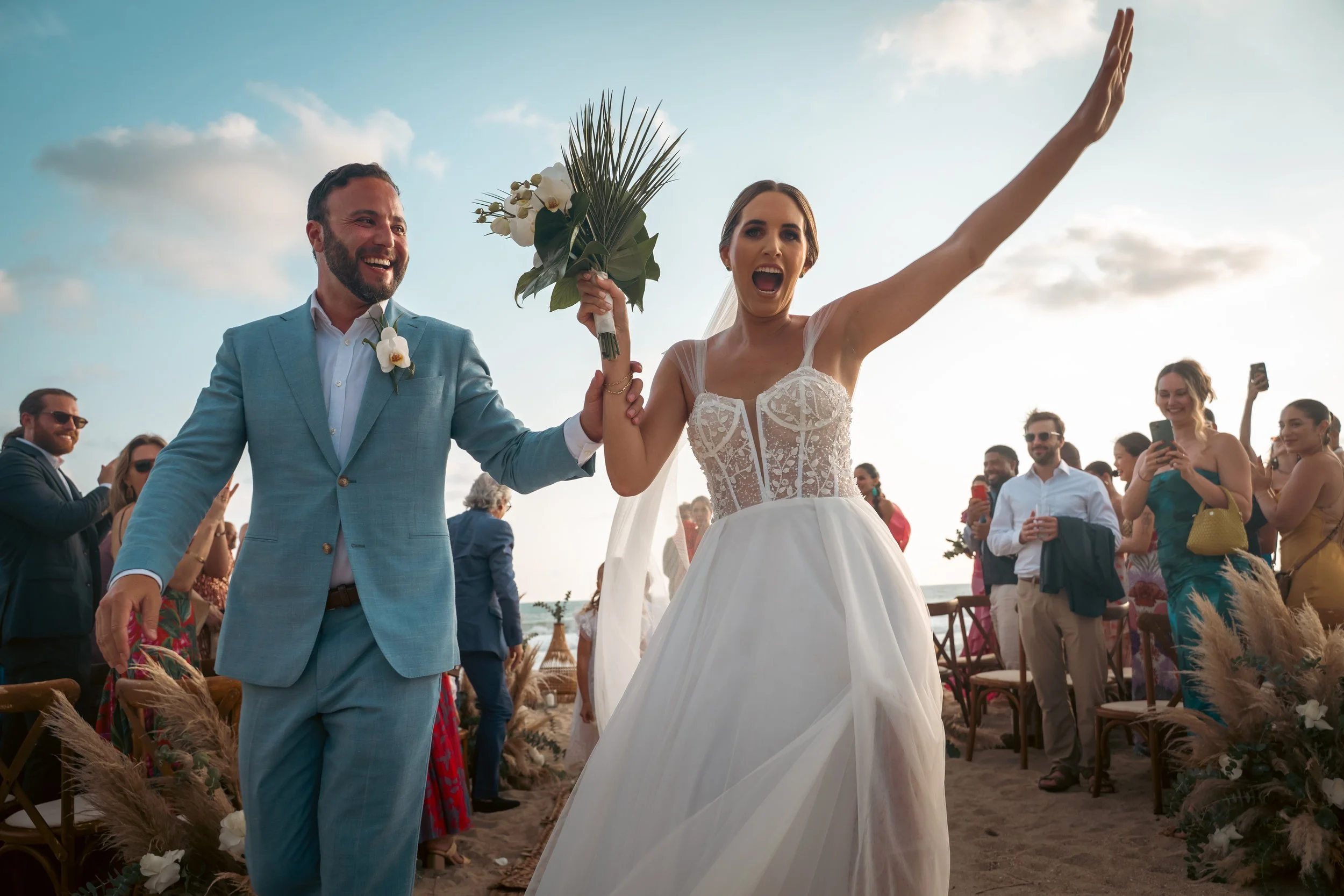 Sunset moments during a destination wedding in Puerto Escondido, captured at a private luxury villa for an American couple. Walking the Alley very happy maried couple.