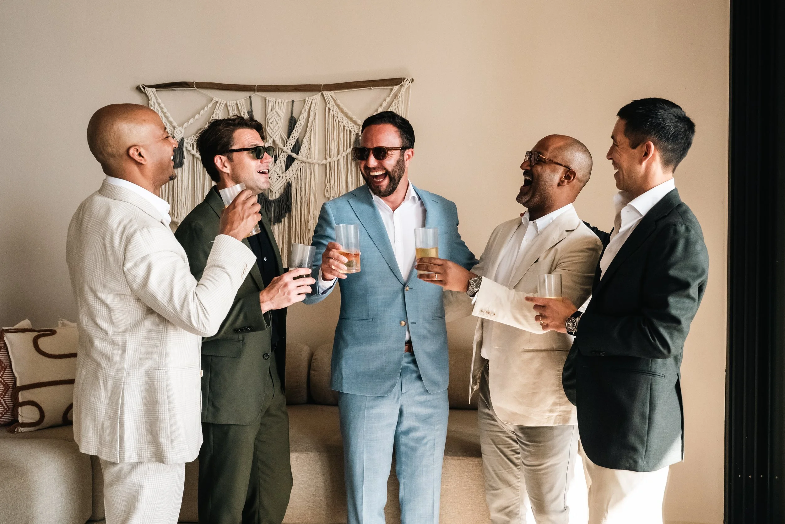 Luxury villa destination wedding in Puerto Escondido, Oaxaca, photographed with a documentary and high-end storytelling style. Groom with his friends cheering before the ceremony.