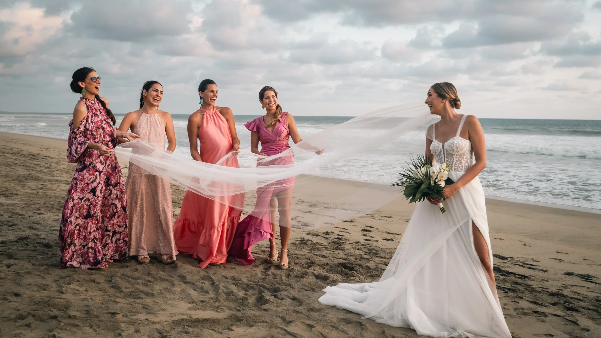 Sunset beach wedding in Puerto Escondido, Oaxaca, photographed with a documentary and high-end storytelling style. Bride and her friends posing after the ceremony for the wedding photoshoot