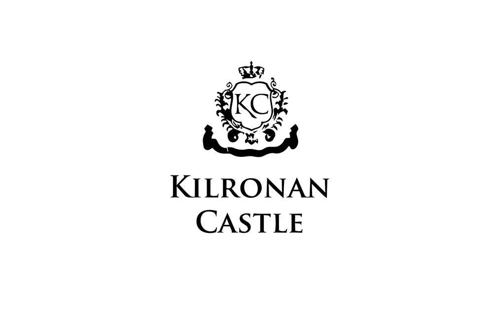 Black and white logo of Kilronan Castle of a shield housing a ‘KC’ emblem and its name beneath.