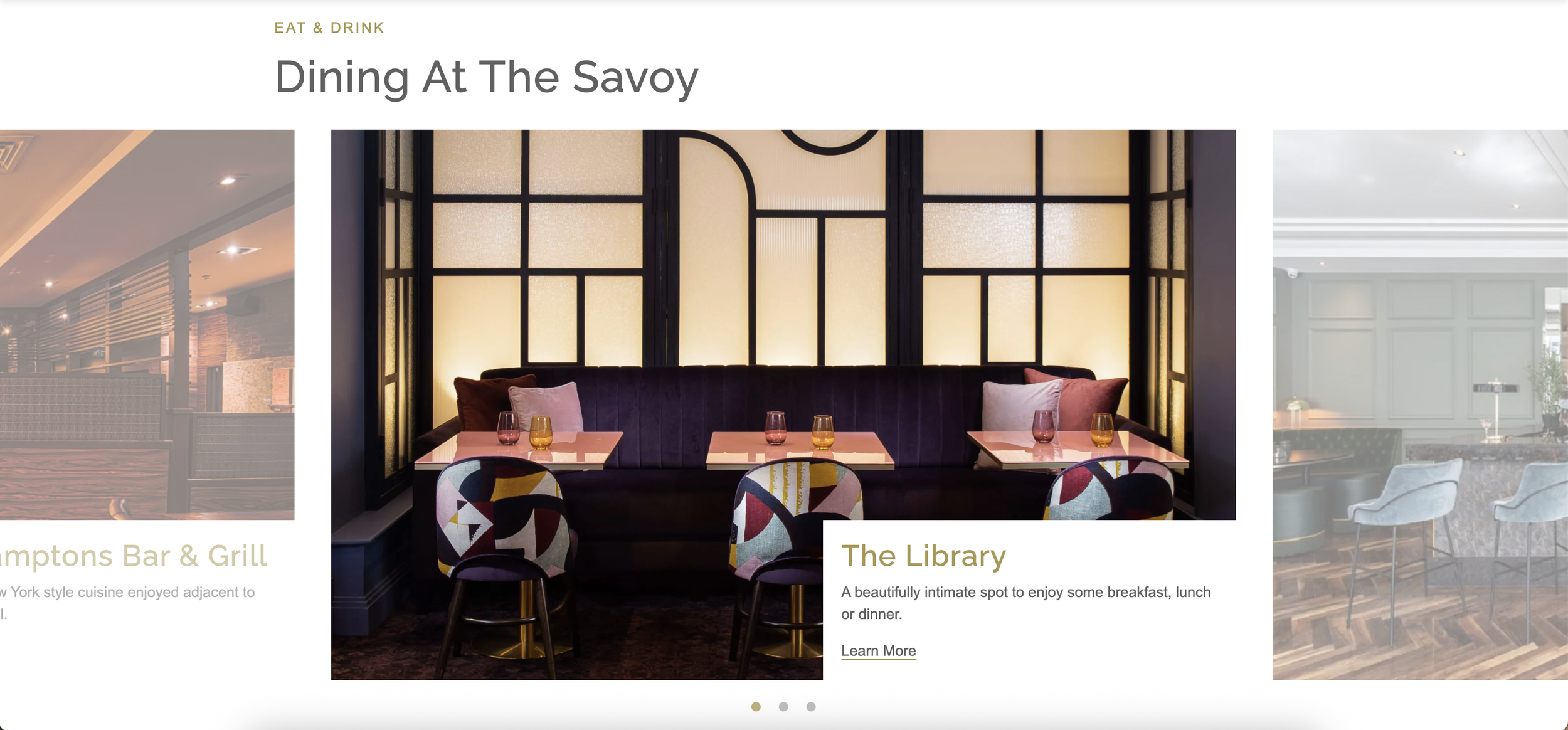 An art deco wall behind a long blue suede bench , three pink tables and three multicoloured seats. 
