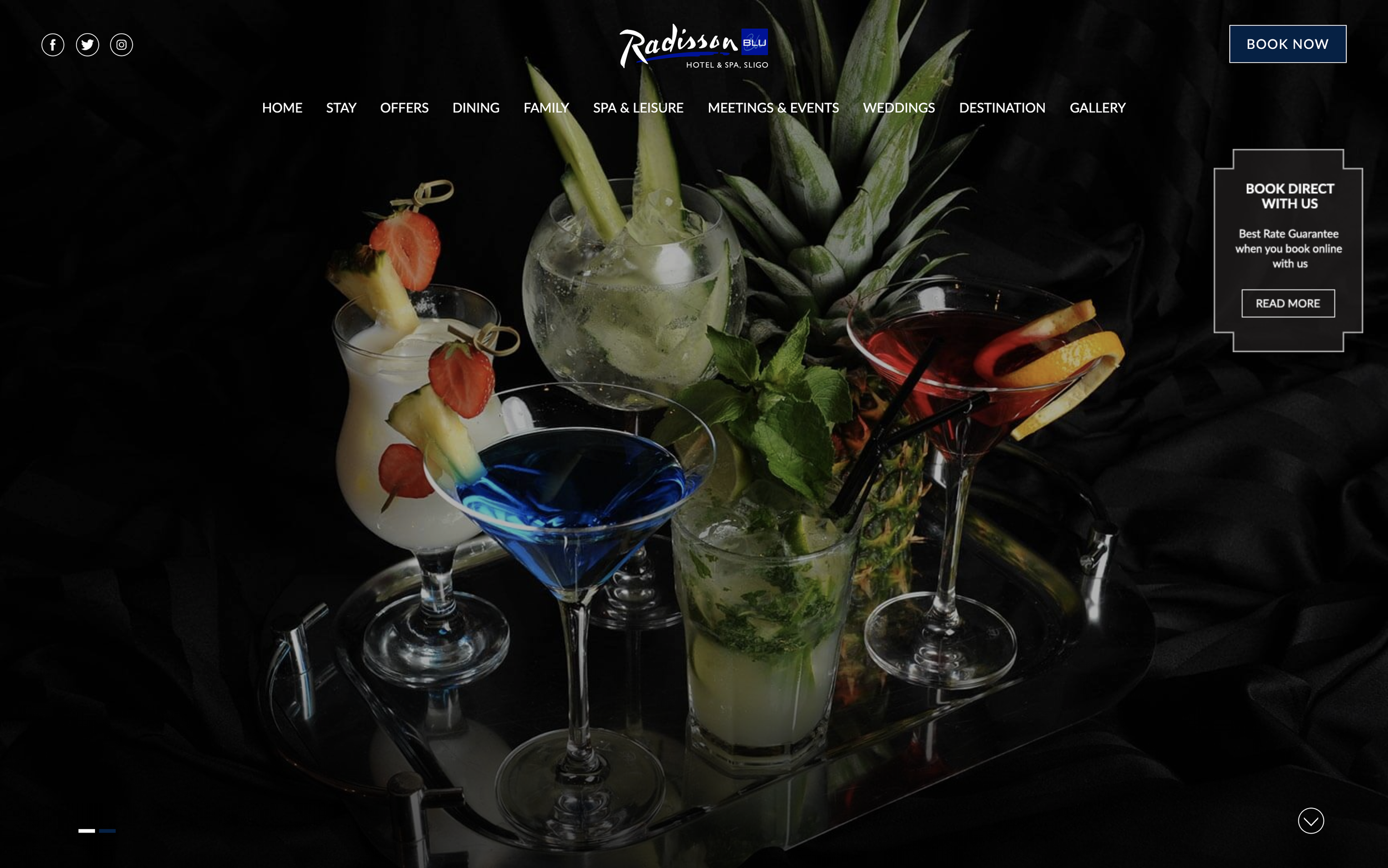 Blue, red, green, white and clear cocktails garnished with different fruit, surrounding a pineapple.