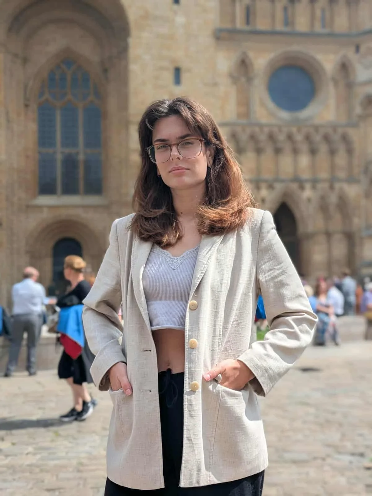 An photograph of Lizzie Nicholls in a blazer outside Lincoln Cathedral.