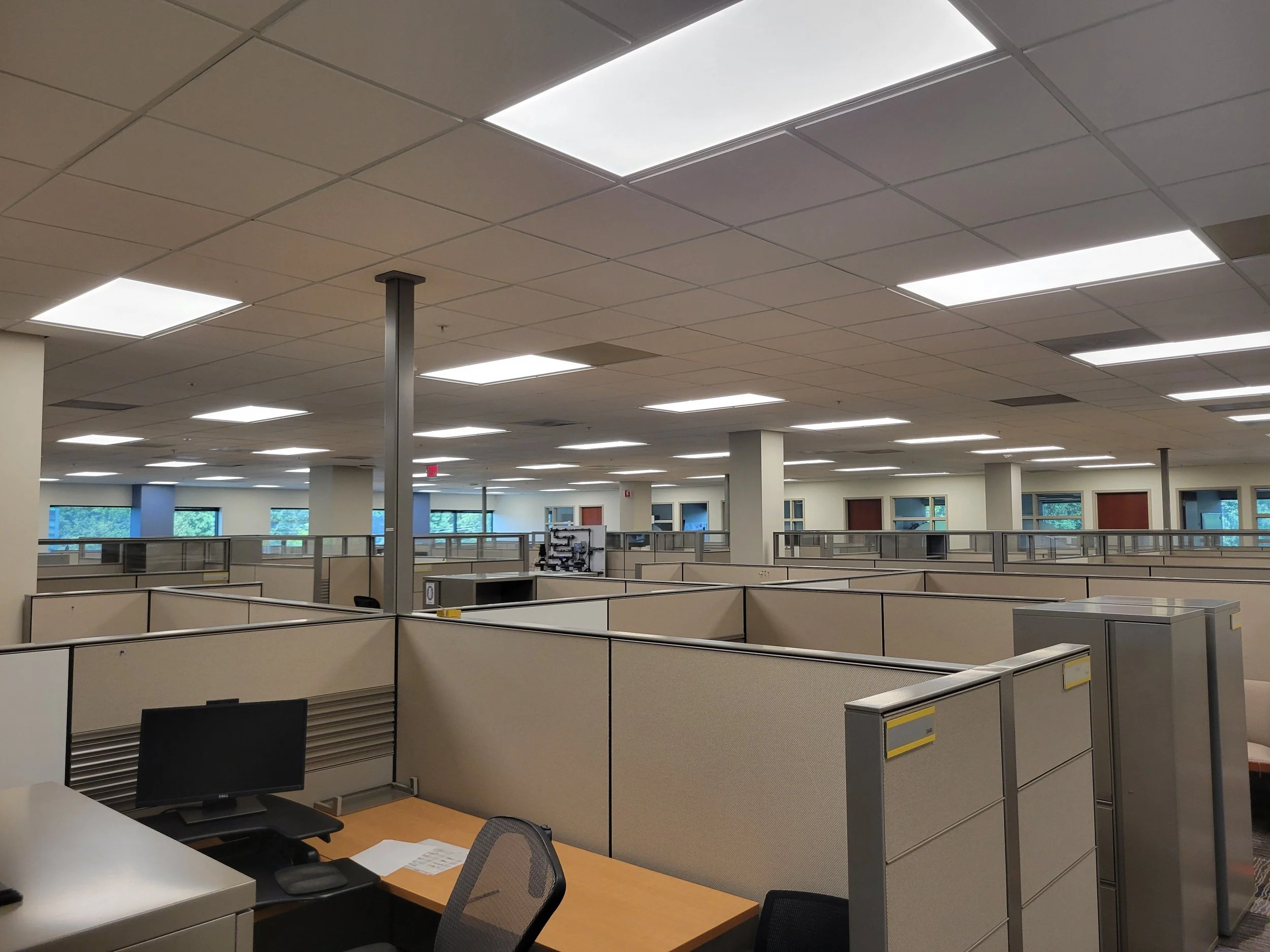 Office space with cubicles and commercial overhead lighting