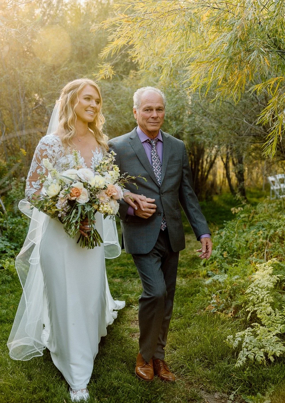 That moment when you are ready to walk down the aisle and your father is accompanying you. Memories that last forever.  Special moments like this is why we love to photograph weddings!