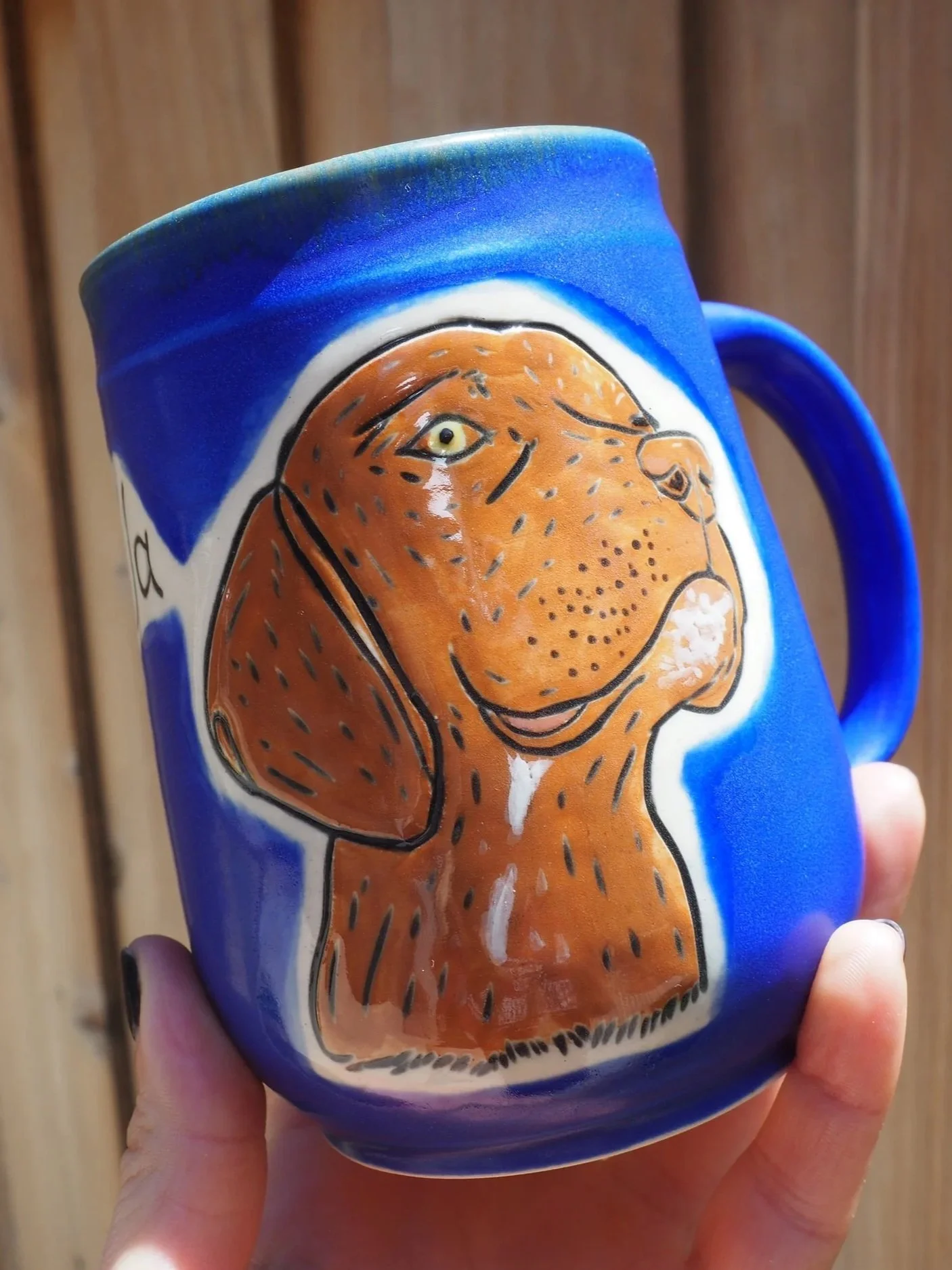Custom pet portrait mug in cobalt blue with a hand-carved brown hound dog