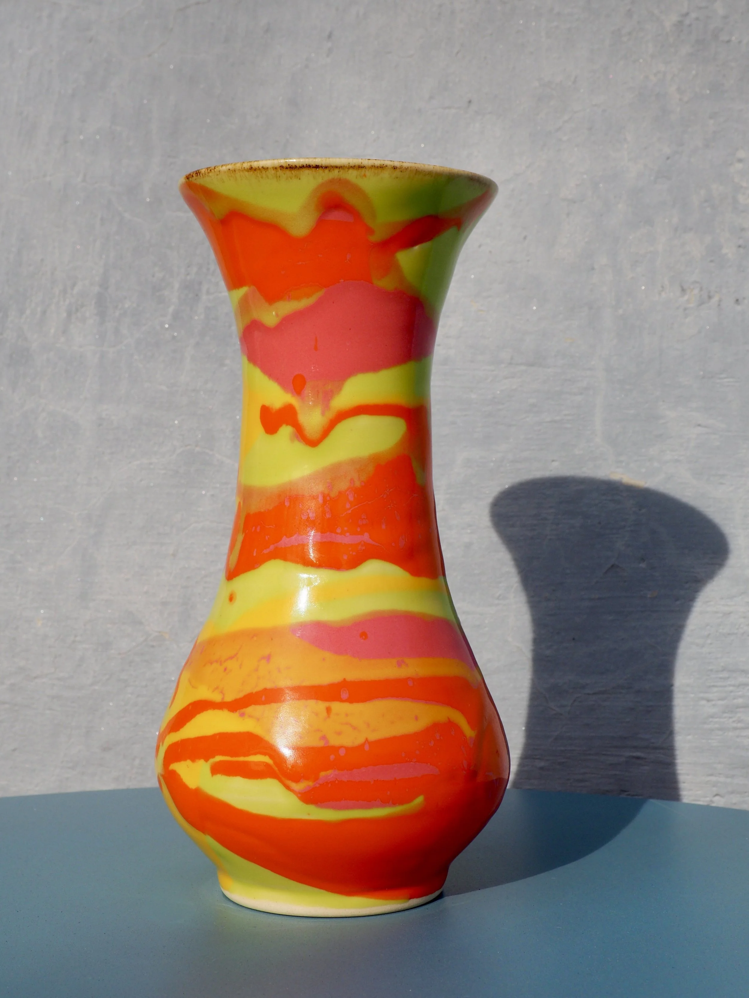 Lava Pot stoneware vase with bright orange, red and yellow marbled glaze, front view