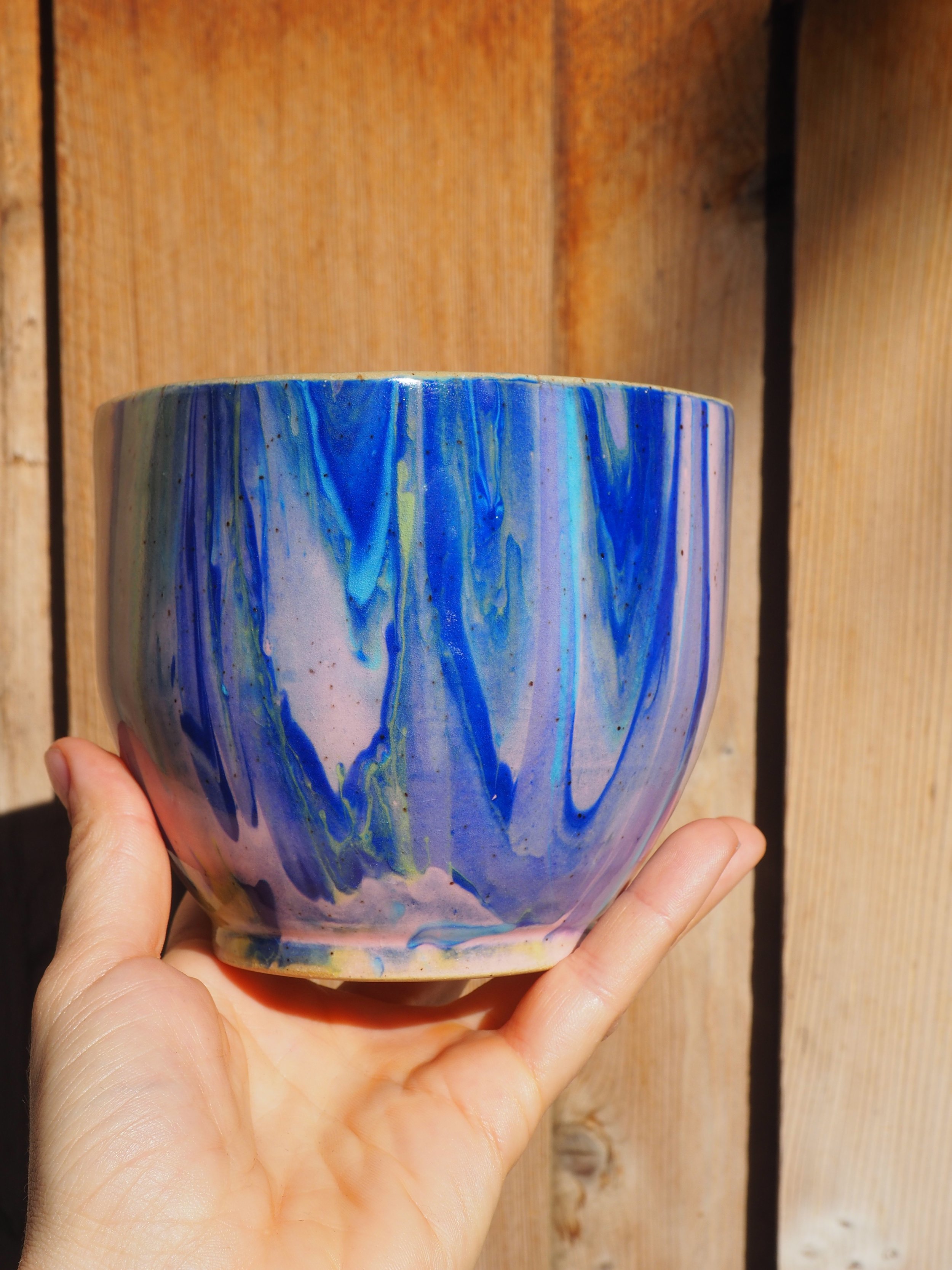 The Big Sparkle Situation, a 24 oz handleless cup marbled in cobalt blue, pink and yellow